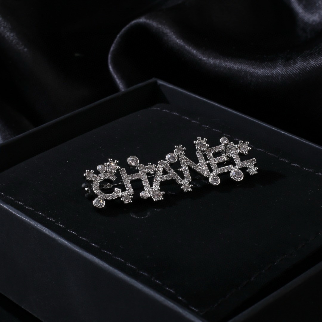 Chanel Crystal Embellished CHANEL Letter Brooch brooch silver tone metal with clear crystal accents 4 5cm width