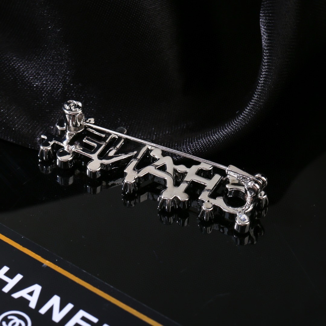 Chanel Crystal Embellished CHANEL Letter Brooch brooch silver tone metal with clear crystal accents 4 5cm width