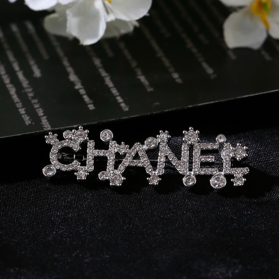 Chanel Crystal Embellished CHANEL Letter Brooch brooch silver tone metal with clear crystal accents 4 5cm width