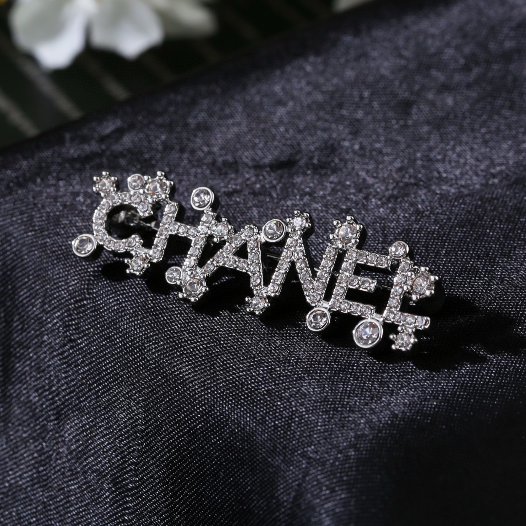 Chanel Crystal Embellished CHANEL Letter Brooch brooch silver tone metal with clear crystal accents 4 5cm width