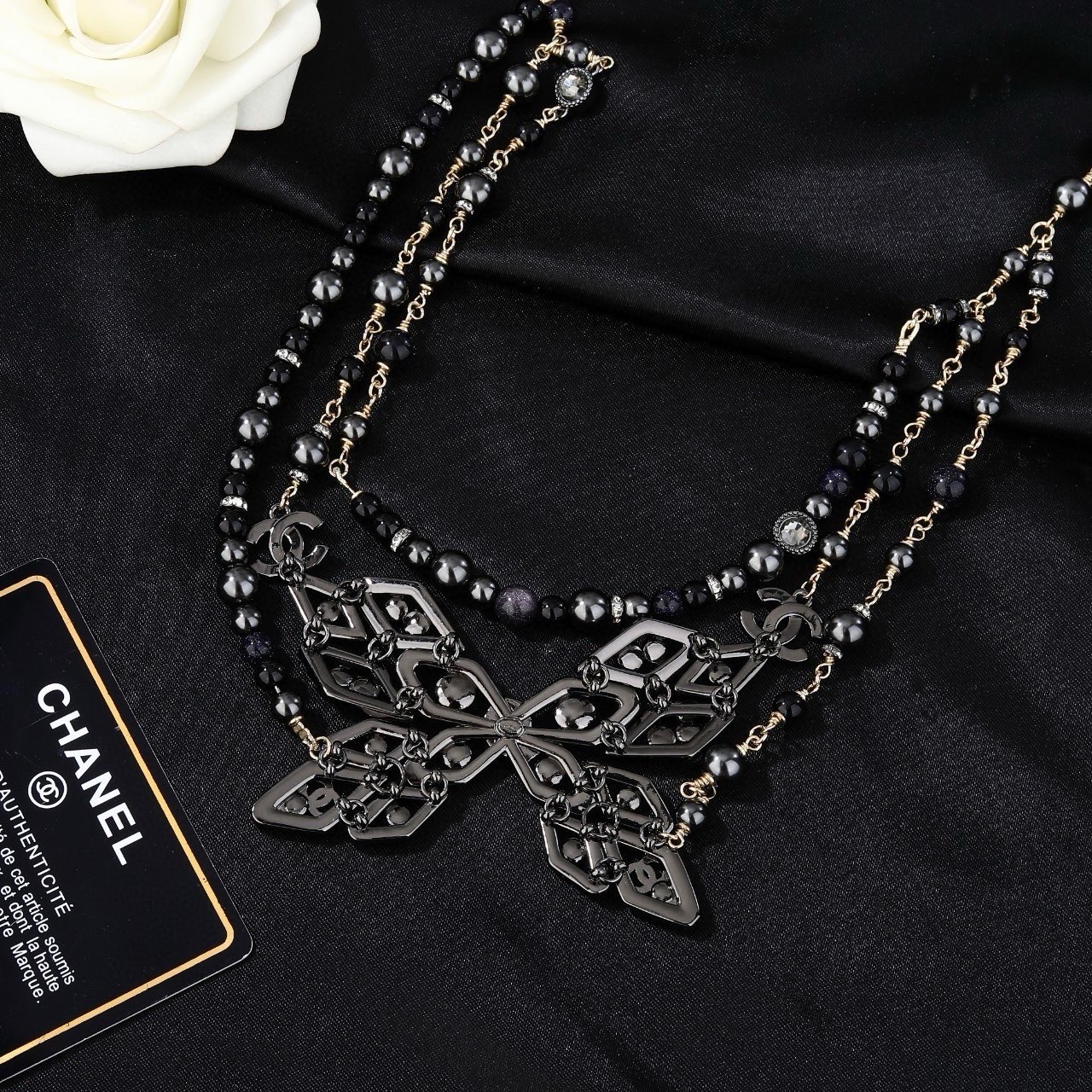 Chanel CC Snowflake Multi-Strand Beaded Chain necklace Gold-tone and gunmetal-tone metal with black beads and clear crystal accents 80cm