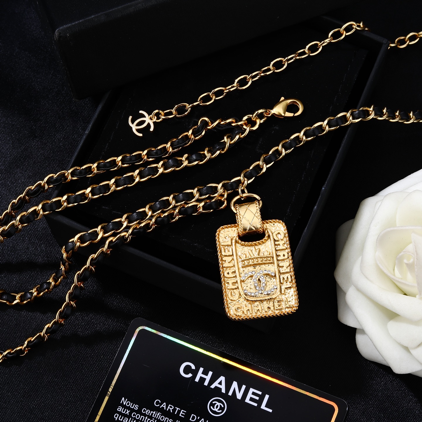 Chanel Goose series necklace gold-tone metal with black leather woven chain clear crystal accents on gold-tone pendant 80cm