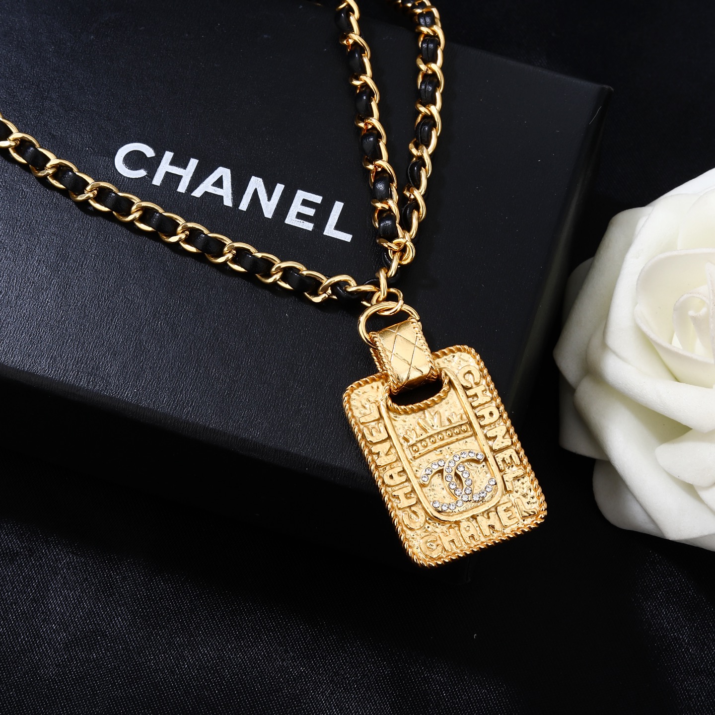 Chanel Goose series necklace gold-tone metal with black leather woven chain clear crystal accents on gold-tone pendant 80cm