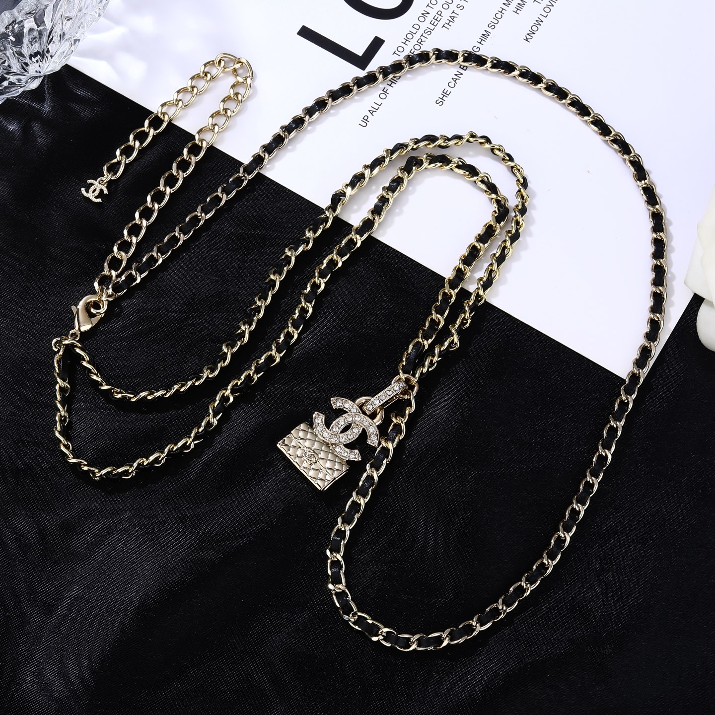 Chanel Goose series CC quilted bag charm chain necklace gold-tone metal with black leather inlay clear crystal accents 80cm