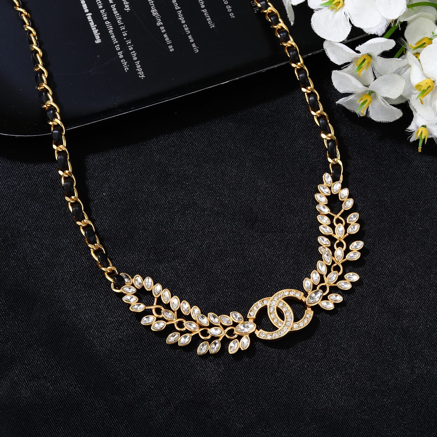 Chanel Goose series crystal leaf CC logo chain necklace gold tone metal with black leather woven chain clear faceted crystal stones 80cm