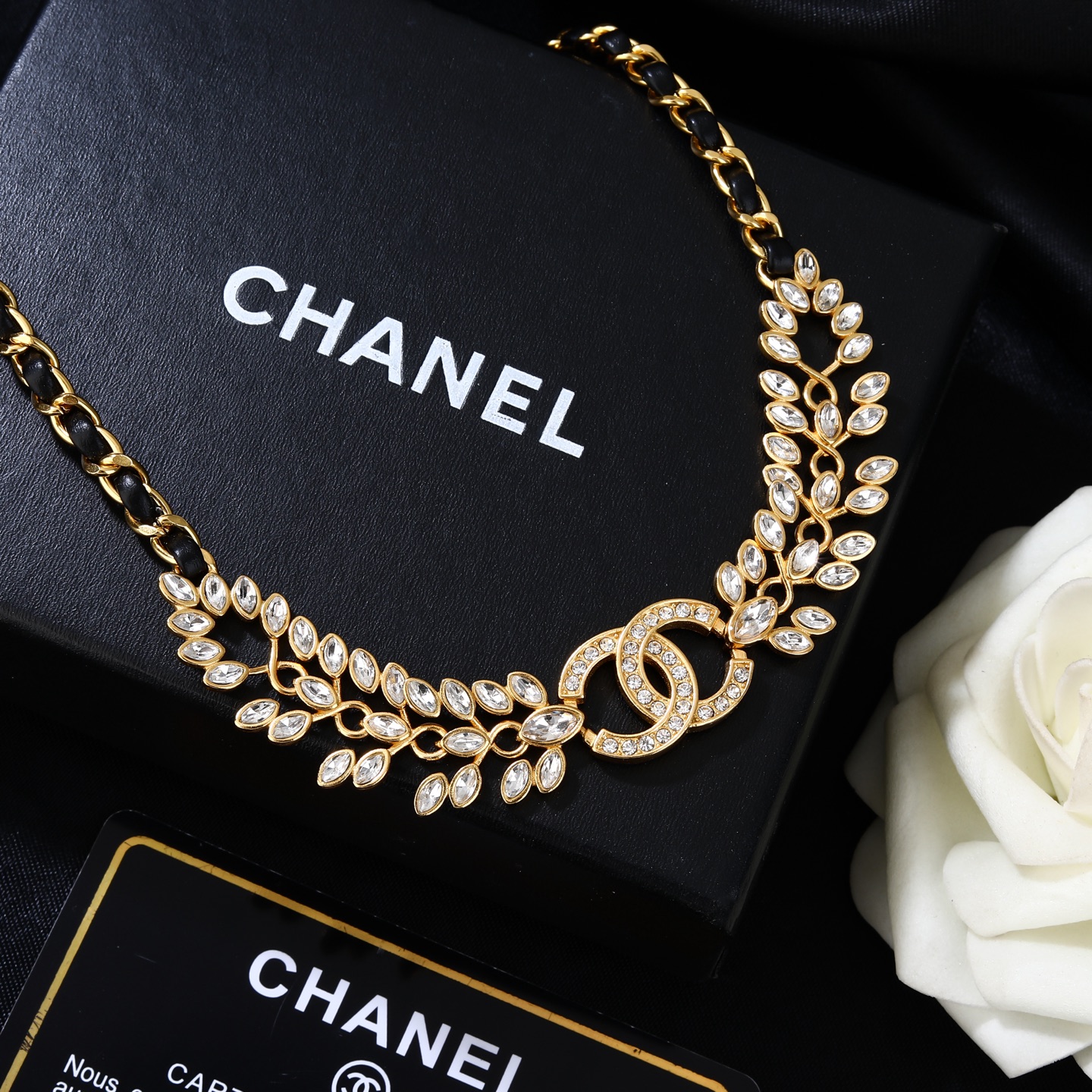 Chanel Goose series crystal leaf CC logo chain necklace gold tone metal with black leather woven chain clear faceted crystal stones 80cm