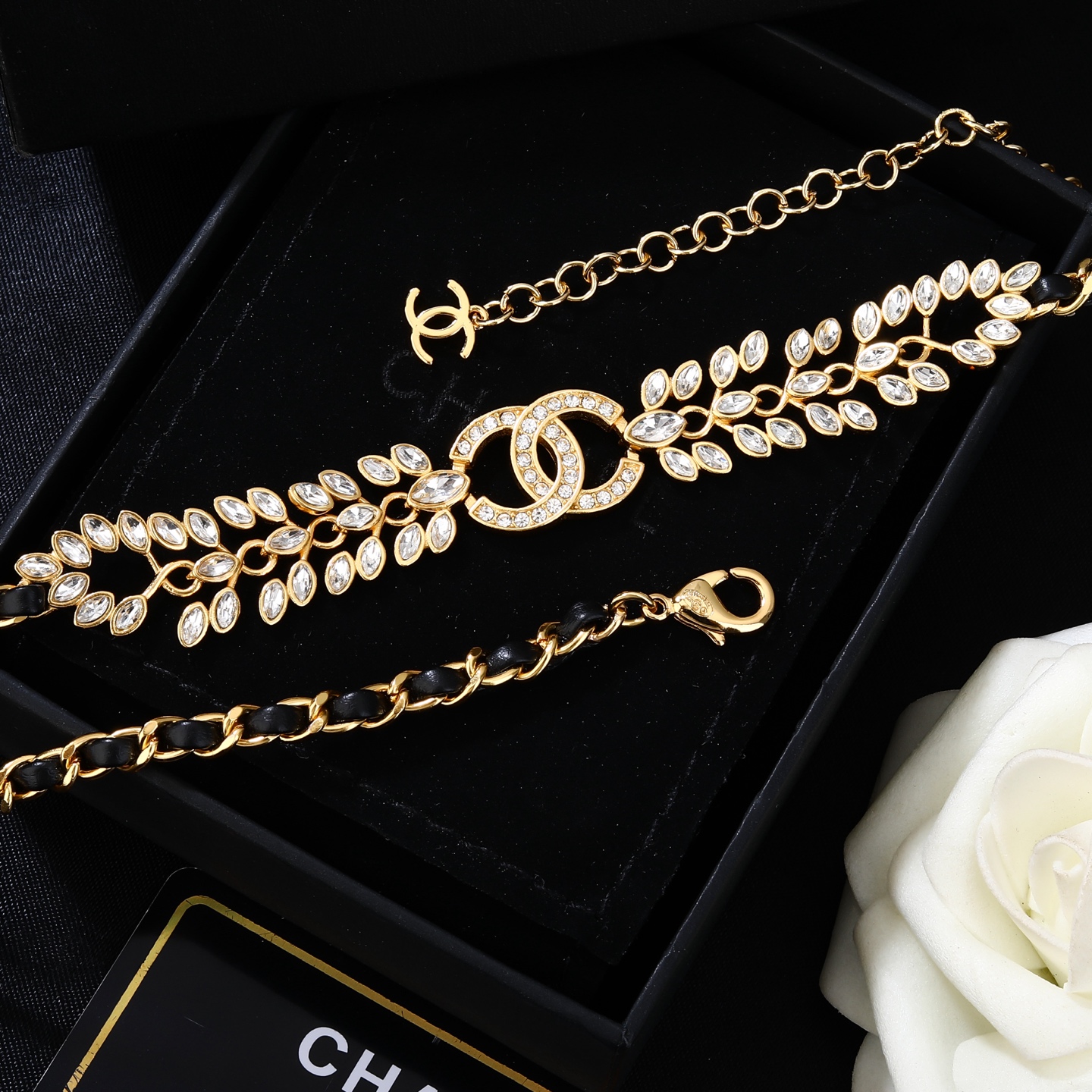 Chanel Goose series crystal leaf CC logo chain necklace gold tone metal with black leather woven chain clear faceted crystal stones 80cm