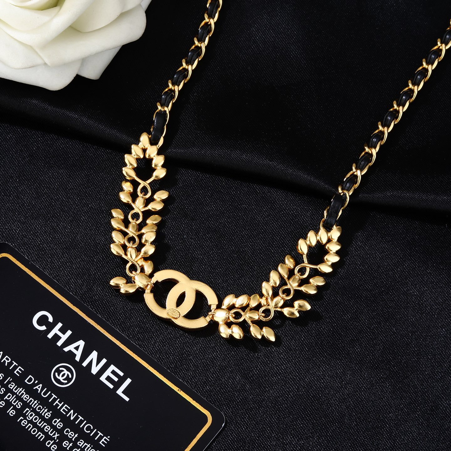 Chanel Goose series crystal leaf CC logo chain necklace gold tone metal with black leather woven chain clear faceted crystal stones 80cm