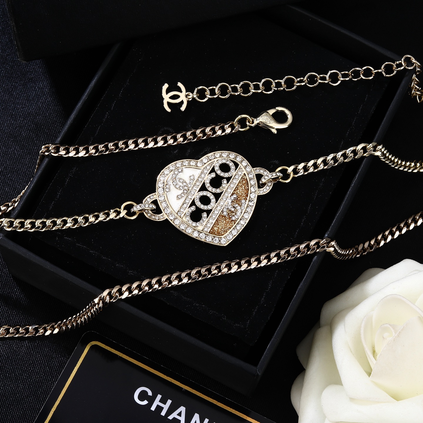 Chanel Coco Heart Waist Chain necklace Light gold tone metal with clear crystal and champagne glitter accents white enamel detail 80cm with 15cm extension