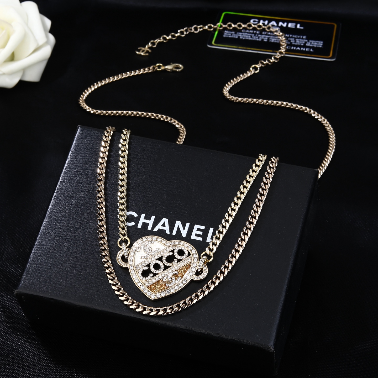 Chanel Coco Heart Waist Chain necklace Light gold tone metal with clear crystal and champagne glitter accents white enamel detail 80cm with 15cm extension