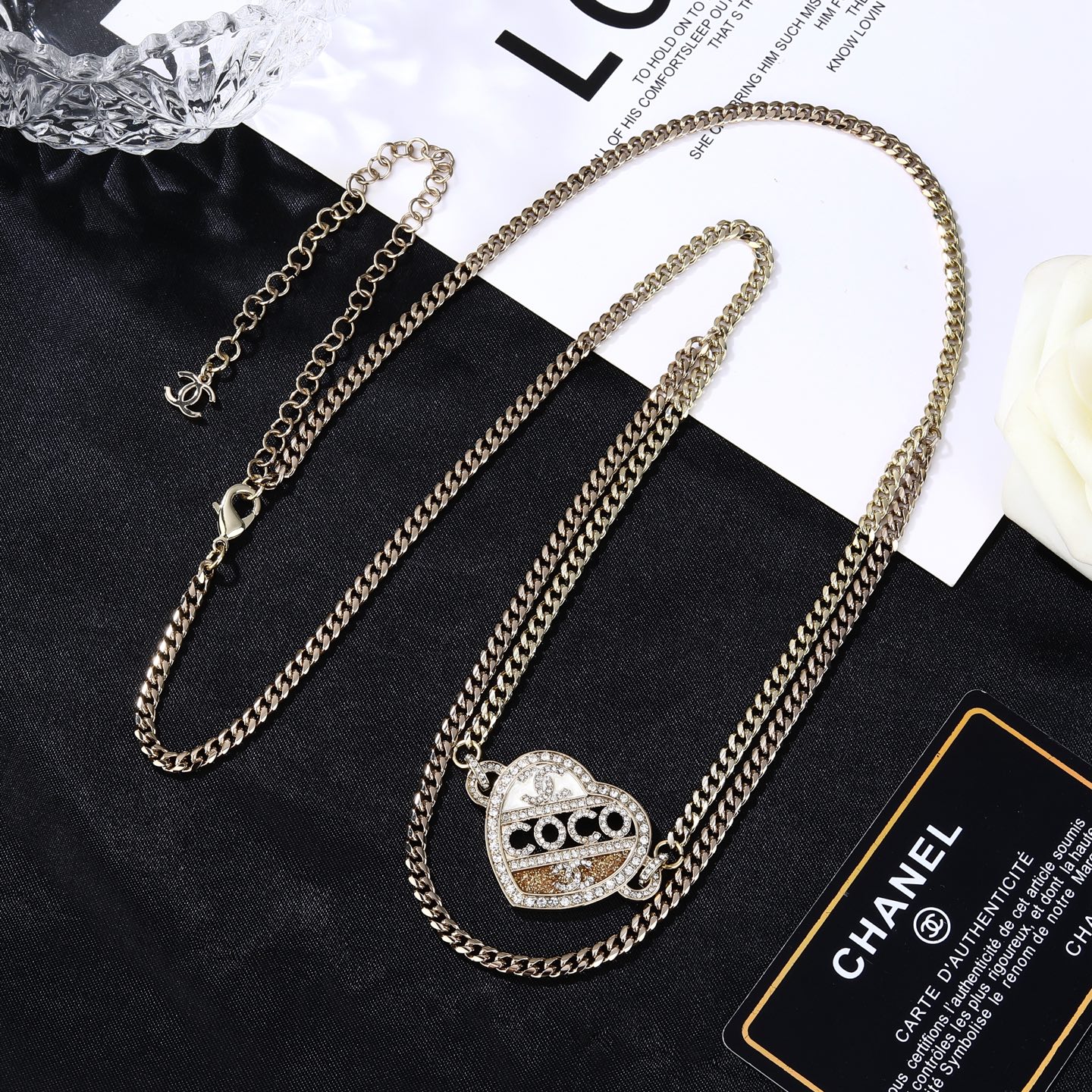 Chanel Coco Heart Waist Chain necklace Light gold tone metal with clear crystal and champagne glitter accents white enamel detail 80cm with 15cm extension