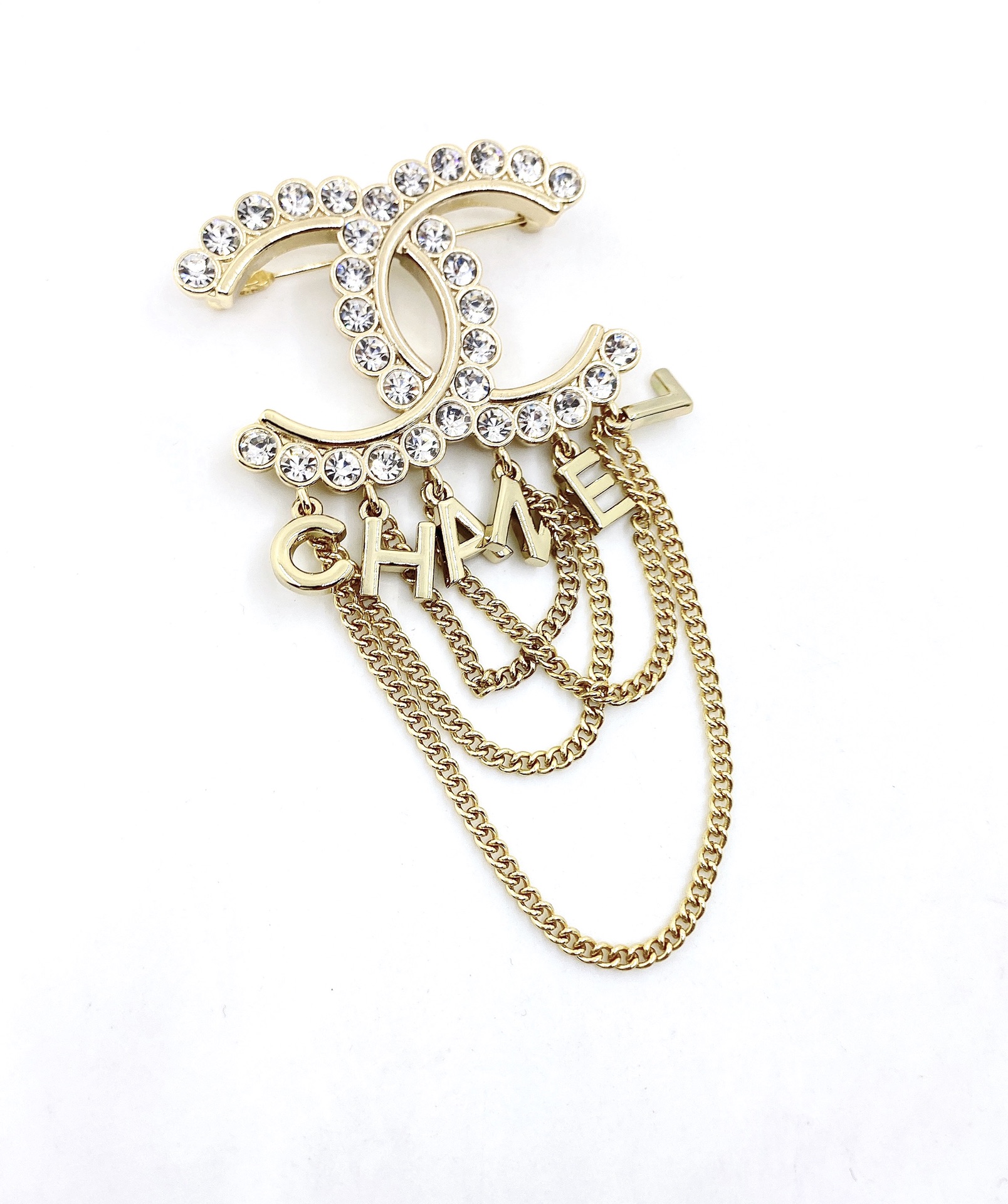 Chanel CC Logo Letter Chain Fringe Brooch brooch Gold-tone metal with clear faceted crystal accents Approximately 6cm width 9cm total drop length with chains