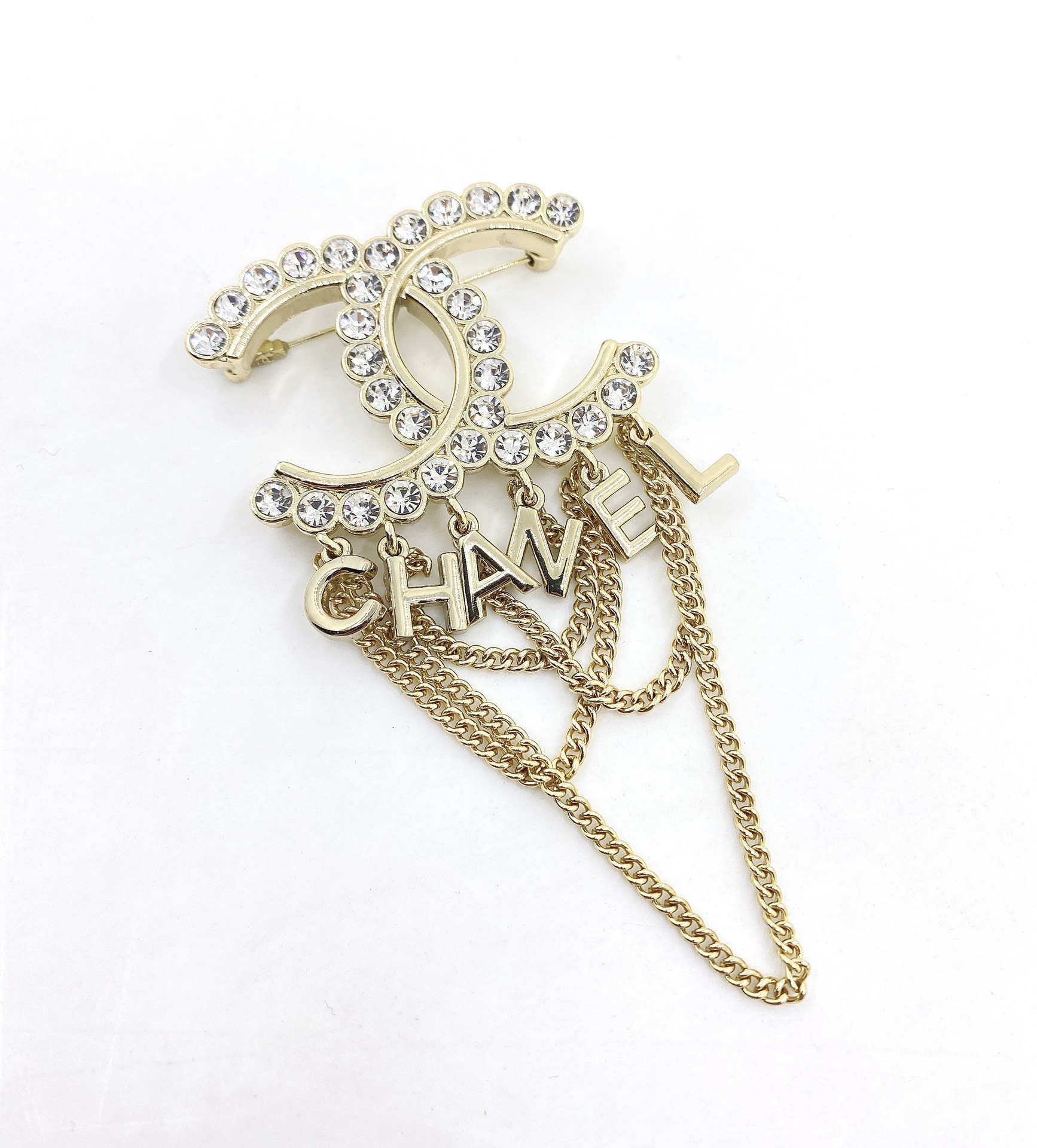 Chanel CC Logo Letter Chain Fringe Brooch brooch Gold-tone metal with clear faceted crystal accents Approximately 6cm width 9cm total drop length with chains