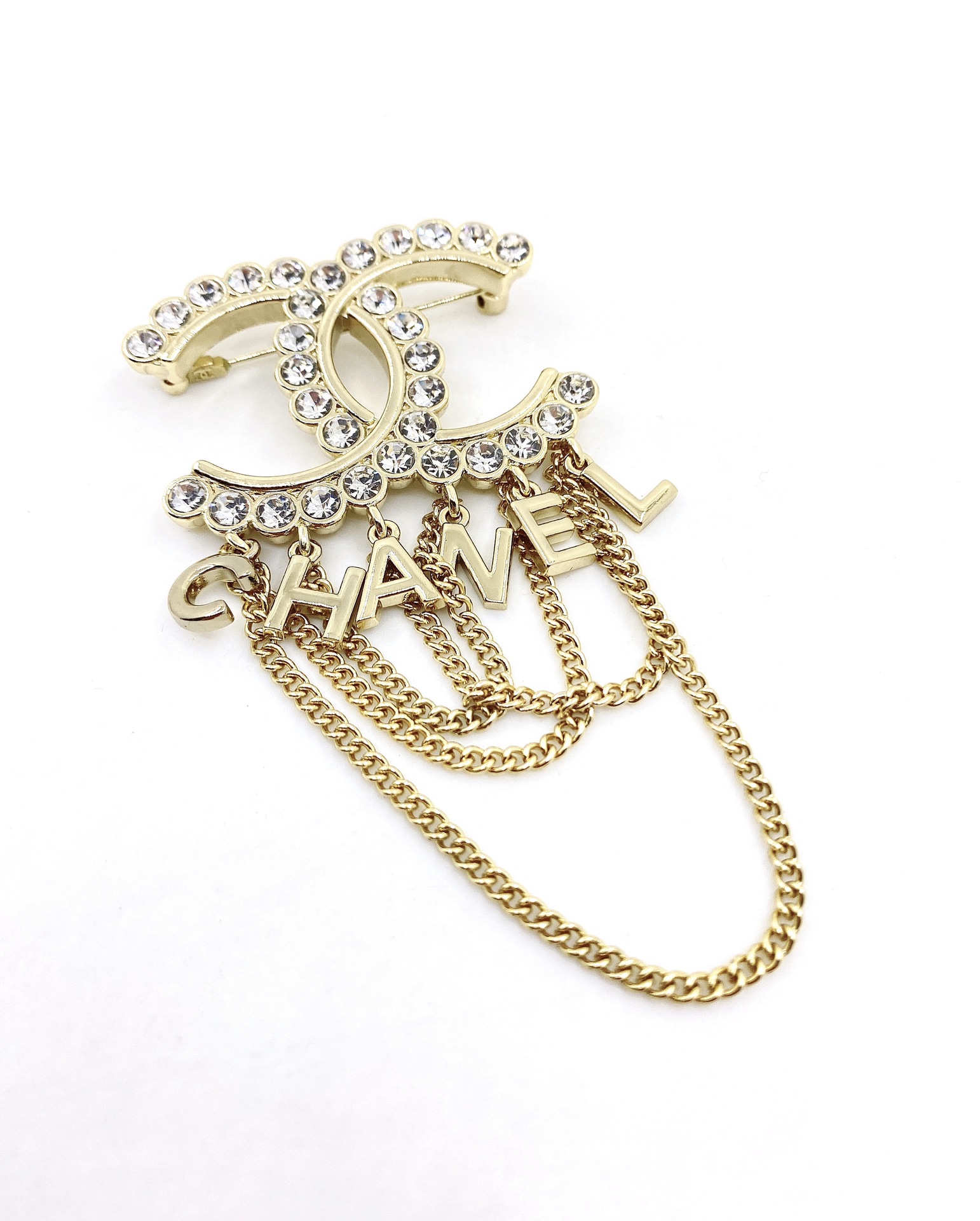 Chanel CC Logo Letter Chain Fringe Brooch brooch Gold-tone metal with clear faceted crystal accents Approximately 6cm width 9cm total drop length with chains