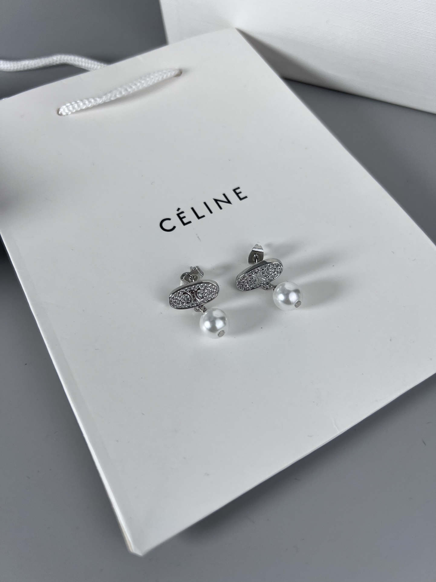 Celine Triomphe Pearl Stud Earrings earrings Gold-tone metal with clear pave crystals and white pearl accents 1 5cm stud diameter