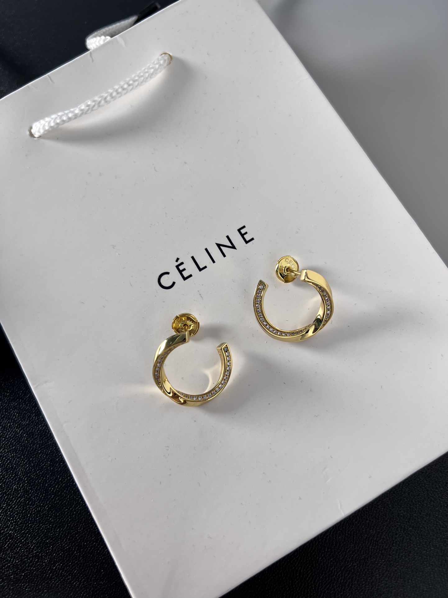 Celine YHED065 Twisted Crystal Hoop Earrings earrings gold-tone metal with clear crystal accents 2 5cm outer hoop diameter
