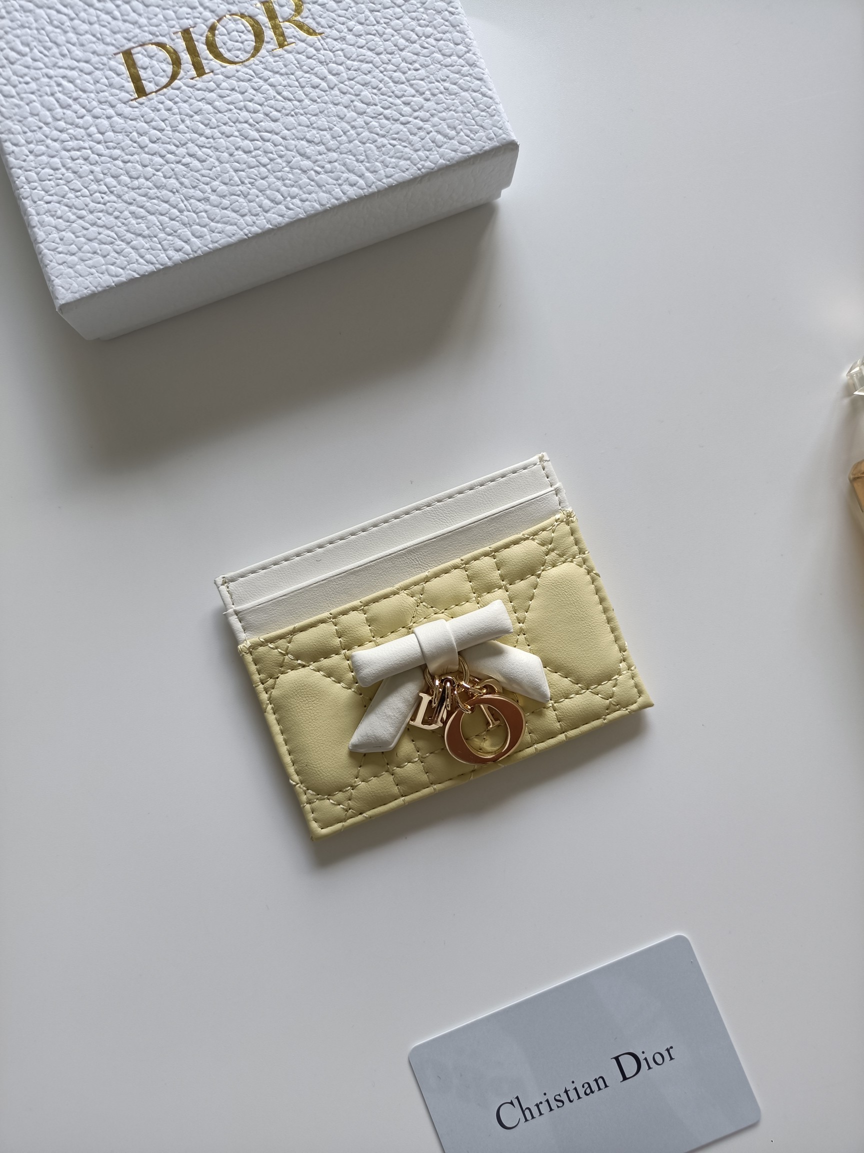 Christian Dior Lady Dior Bow Charm Card Holder brooch Pale yellow lambskin leather with white trim white fabric bow rose gold-tone metal hardware 10 5 8 0 5cm
