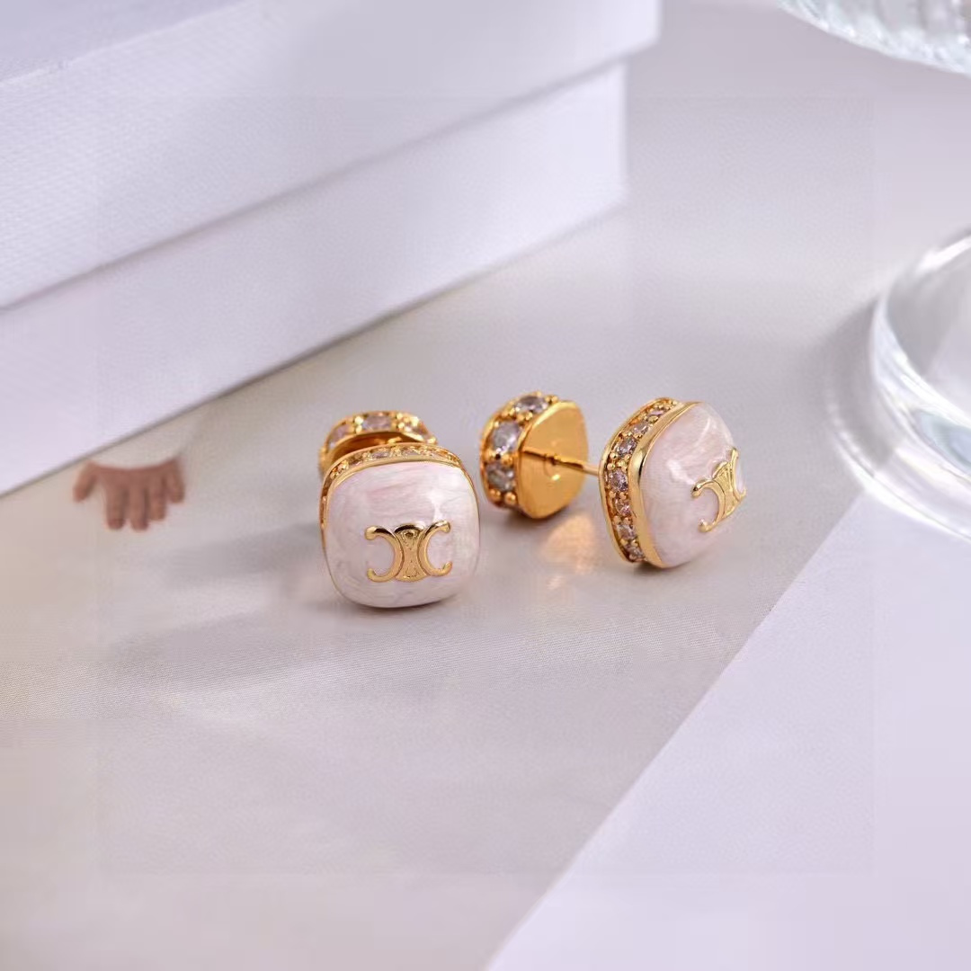 Celine Triomphe Square Stud Earrings earrings Gold-tone metal with clear cubic zirconia accents available in black enamel and white mother-of-pearl face options with gold Triomphe logo 1cm stud diameter