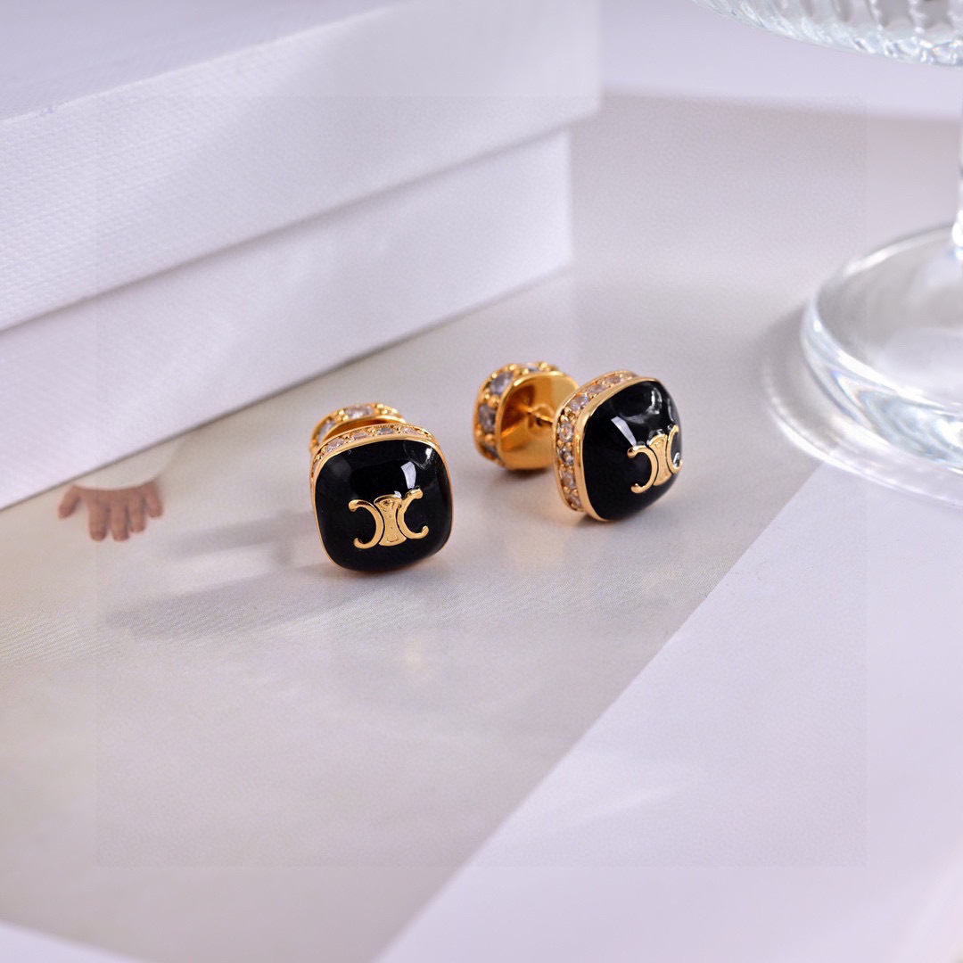 Celine Triomphe Square Stud Earrings earrings Gold-tone metal with clear cubic zirconia accents available in black enamel and white mother-of-pearl face options with gold Triomphe logo 1cm stud diameter