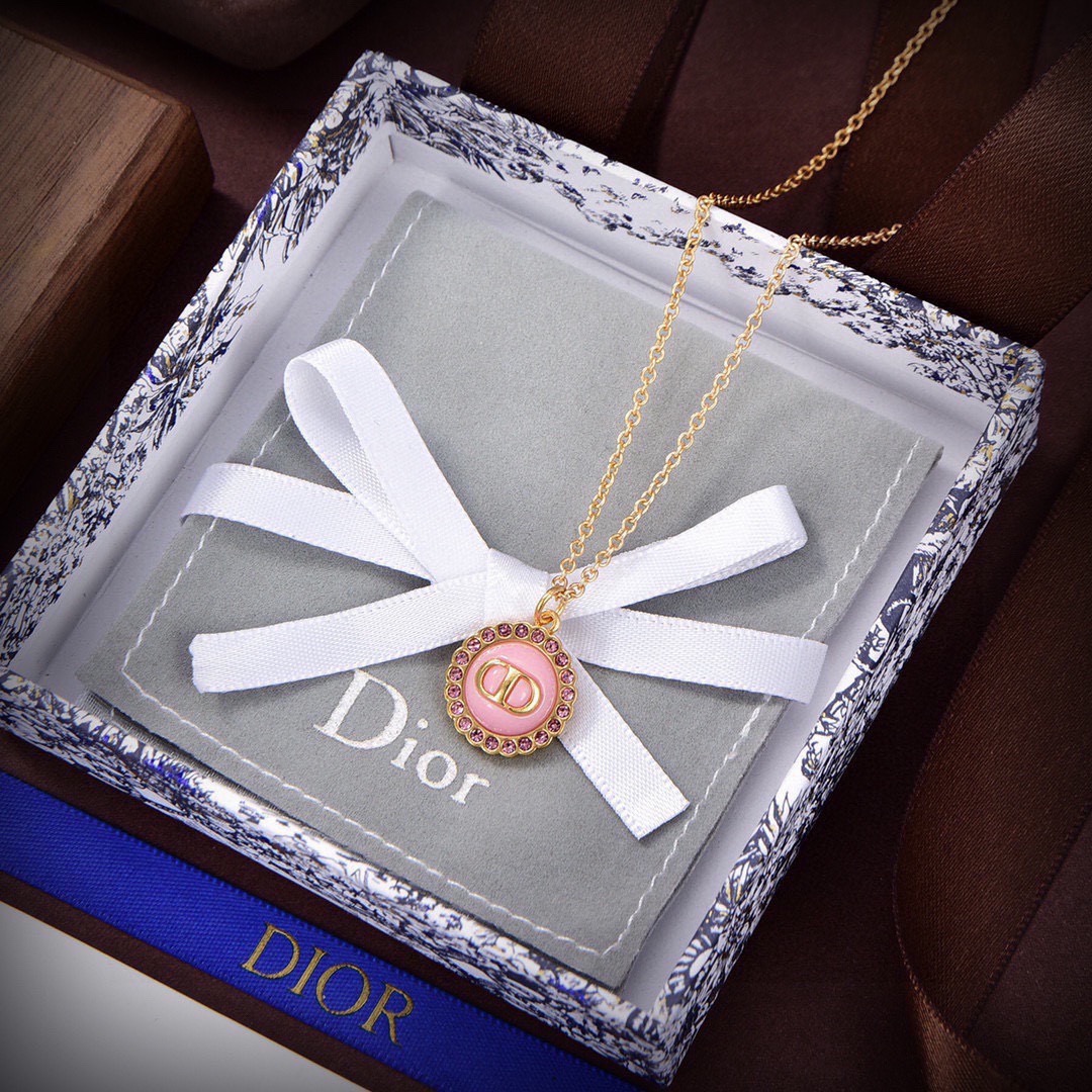 Dior Petit CD necklace Gold-toned metal with black glass center and white resin pearl accents 42cm