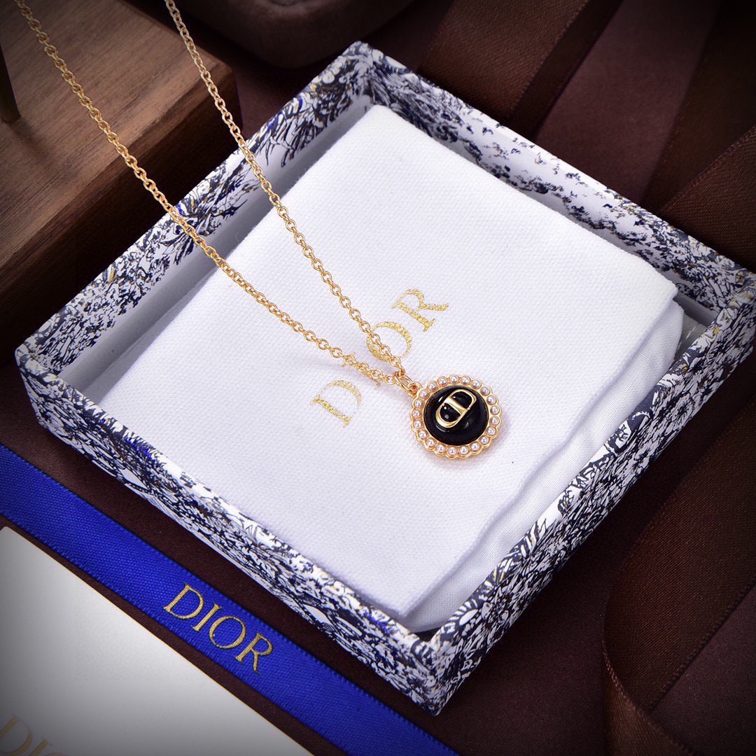 Dior Petit CD necklace Gold-toned metal with black glass center and white resin pearl accents 42cm