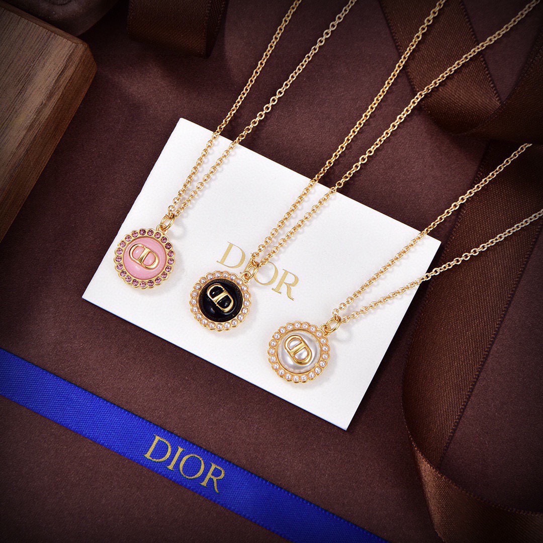 Dior Petit CD necklace Gold-toned metal with black glass center and white resin pearl accents 42cm