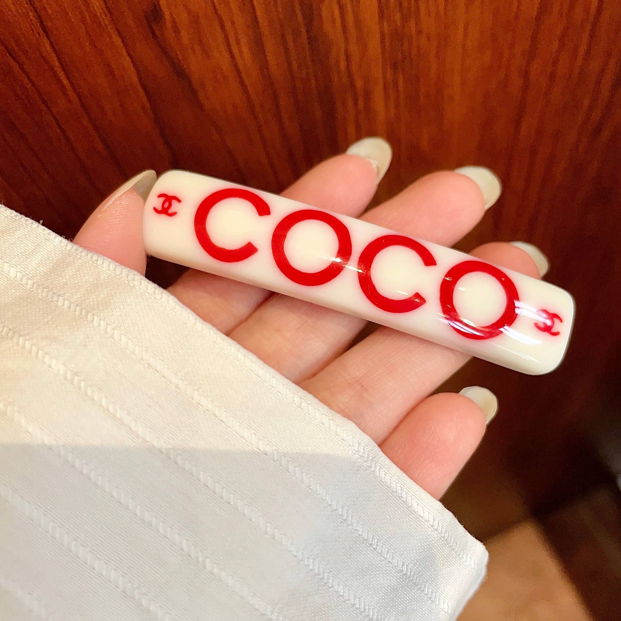 Chanel COCO brooch white base with red printed logos and text 6cm
