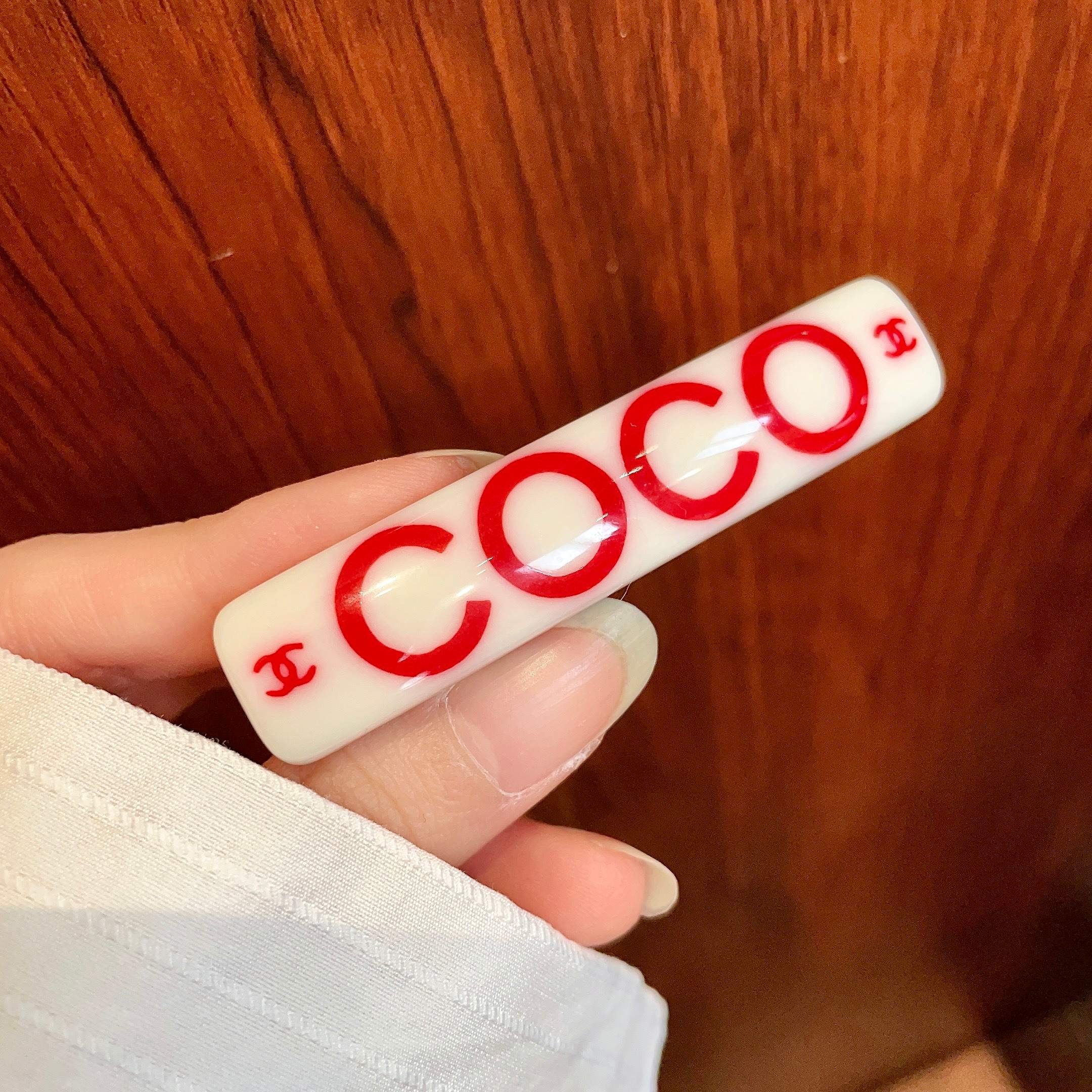 Chanel COCO brooch white base with red printed logos and text 6cm
