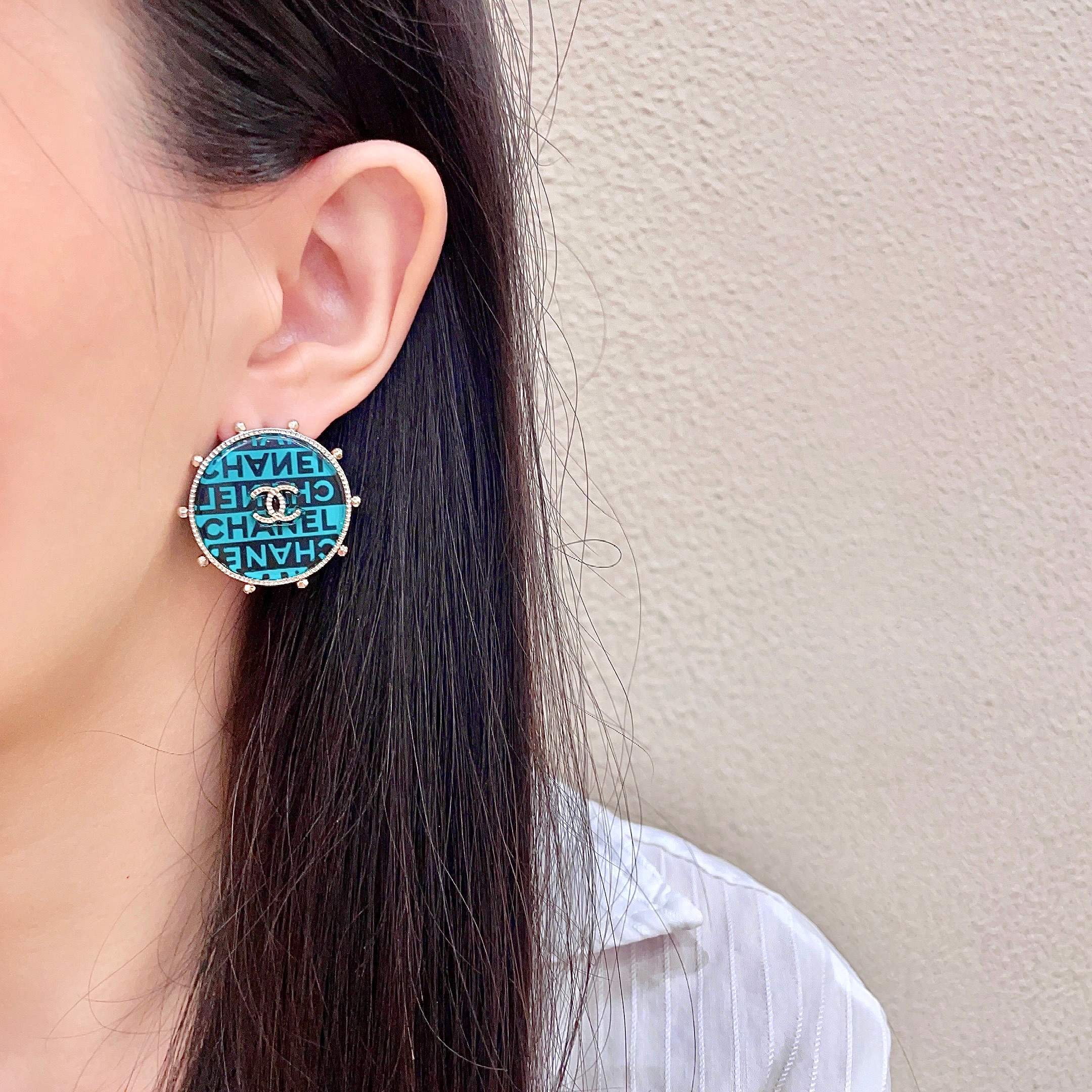 Chanel CC Logo Round Stud Earrings earrings Light gold-tone metal with turquoise and black enamel crystal-embellished interlocking CC logo 2 5cm diameter