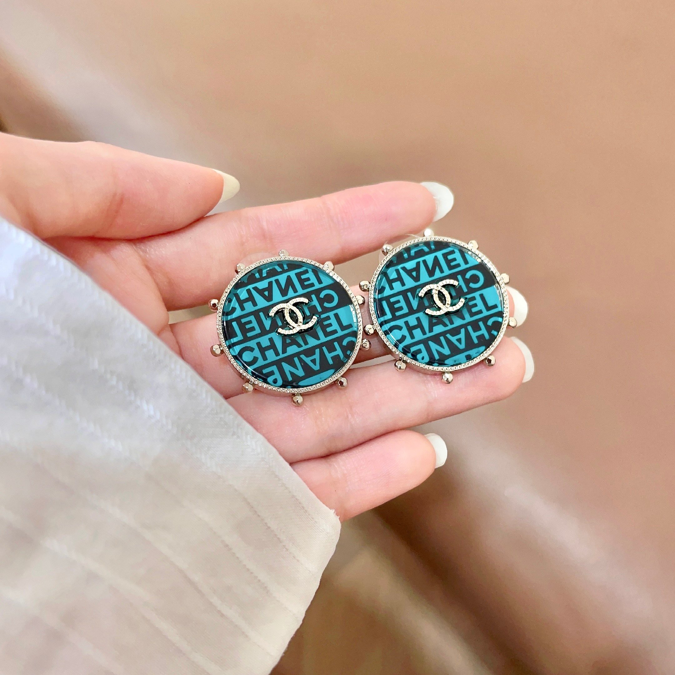 Chanel CC Logo Round Stud Earrings earrings Light gold-tone metal with turquoise and black enamel crystal-embellished interlocking CC logo 2 5cm diameter