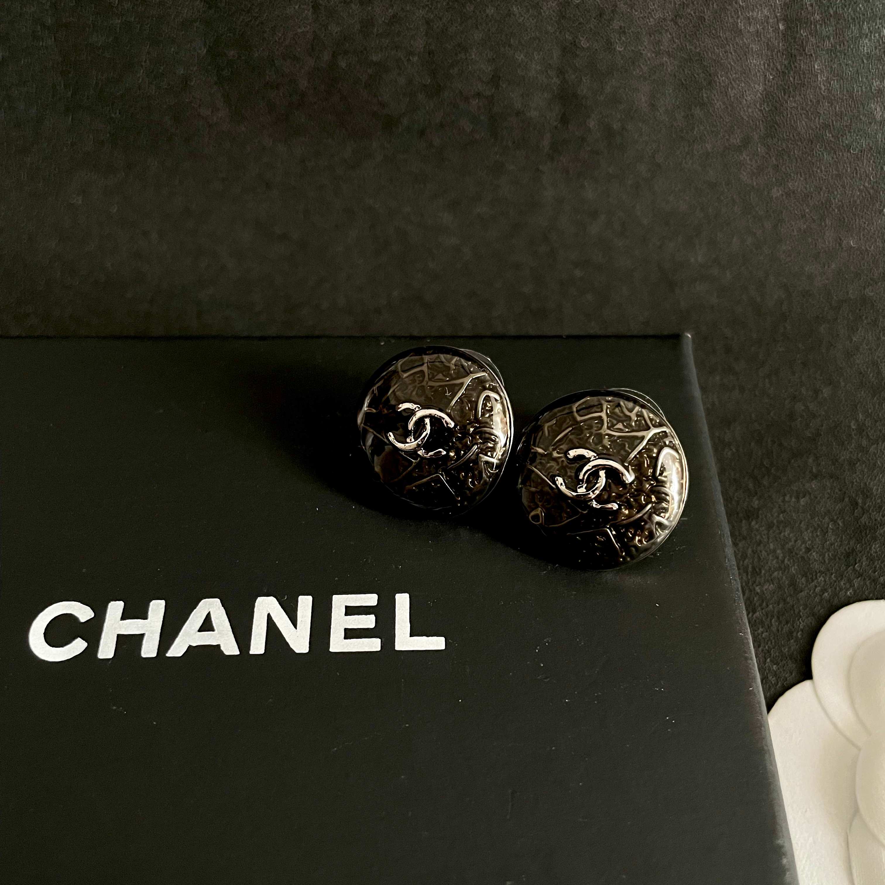 Chanel CC Logo Round Button Stud Earrings earrings ruthenium dark gunmetal with silver-tone interlocking CC logo dark translucent resin base with silver filigree detailing 1 5cm diameter