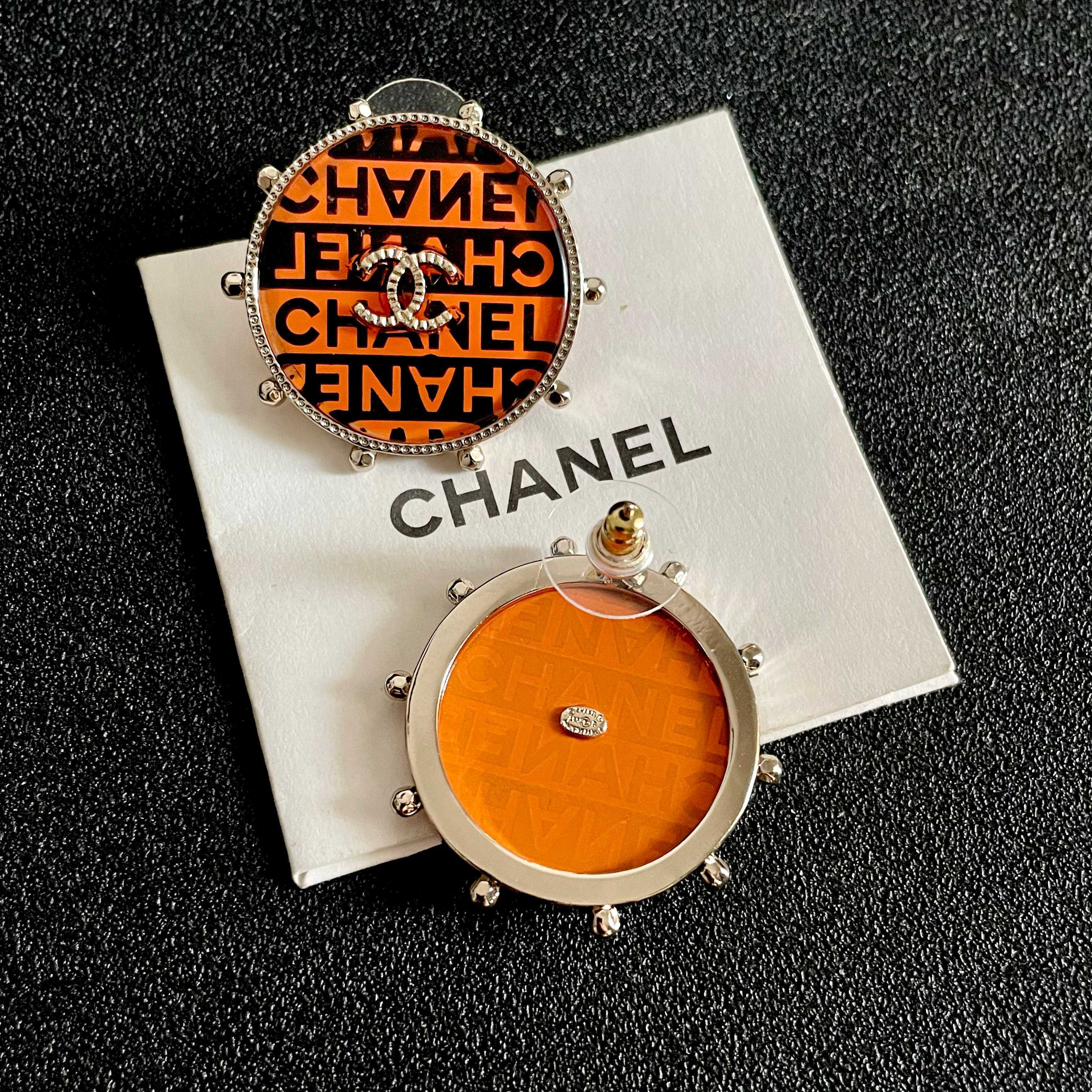 Chanel CC Logo Round Printed Stud Earrings earrings Gold-tone metal with clear crystal accents orange and black enamel printed with Chanel text 2 5cm diameter