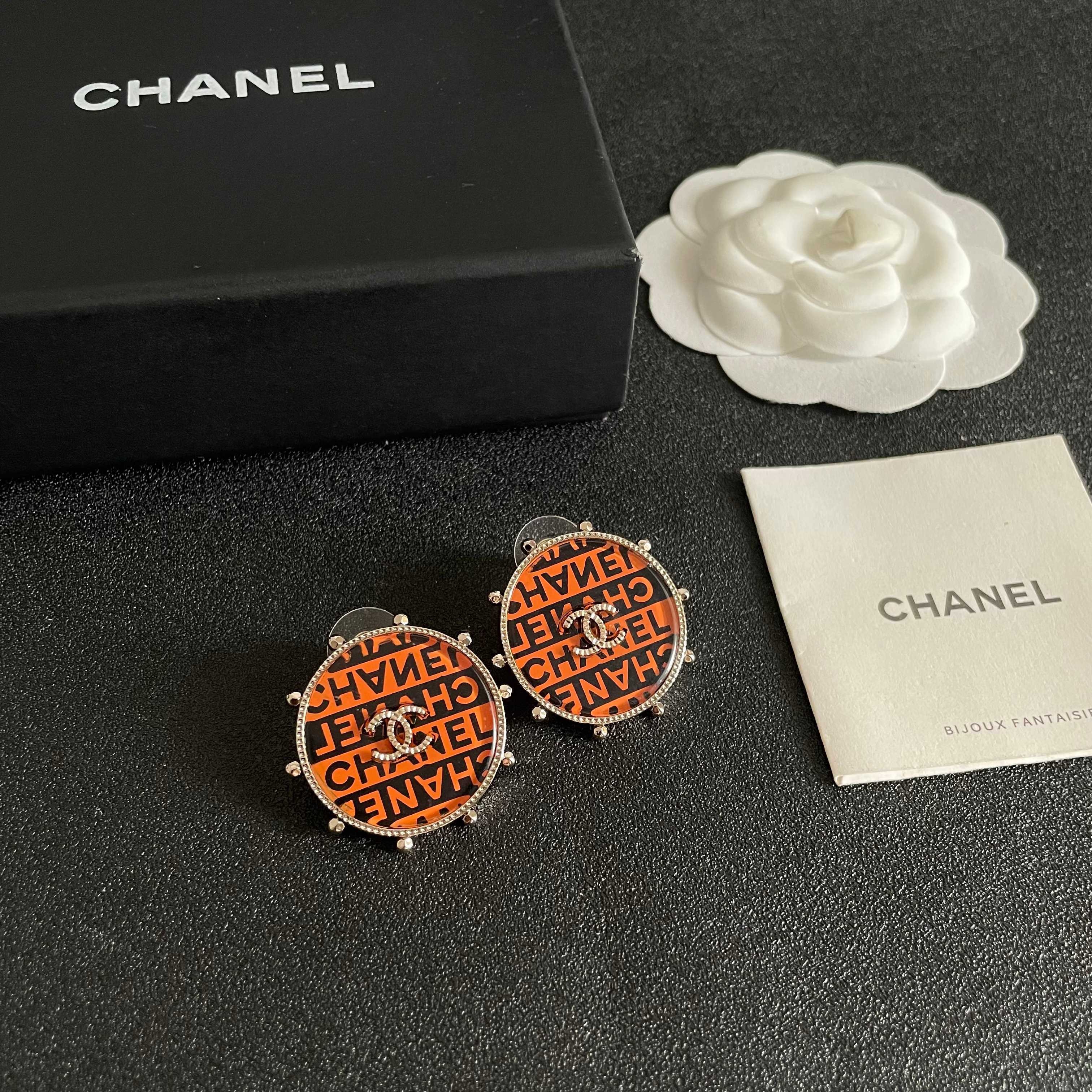 Chanel CC Logo Round Printed Stud Earrings earrings Gold-tone metal with clear crystal accents orange and black enamel printed with Chanel text 2 5cm diameter
