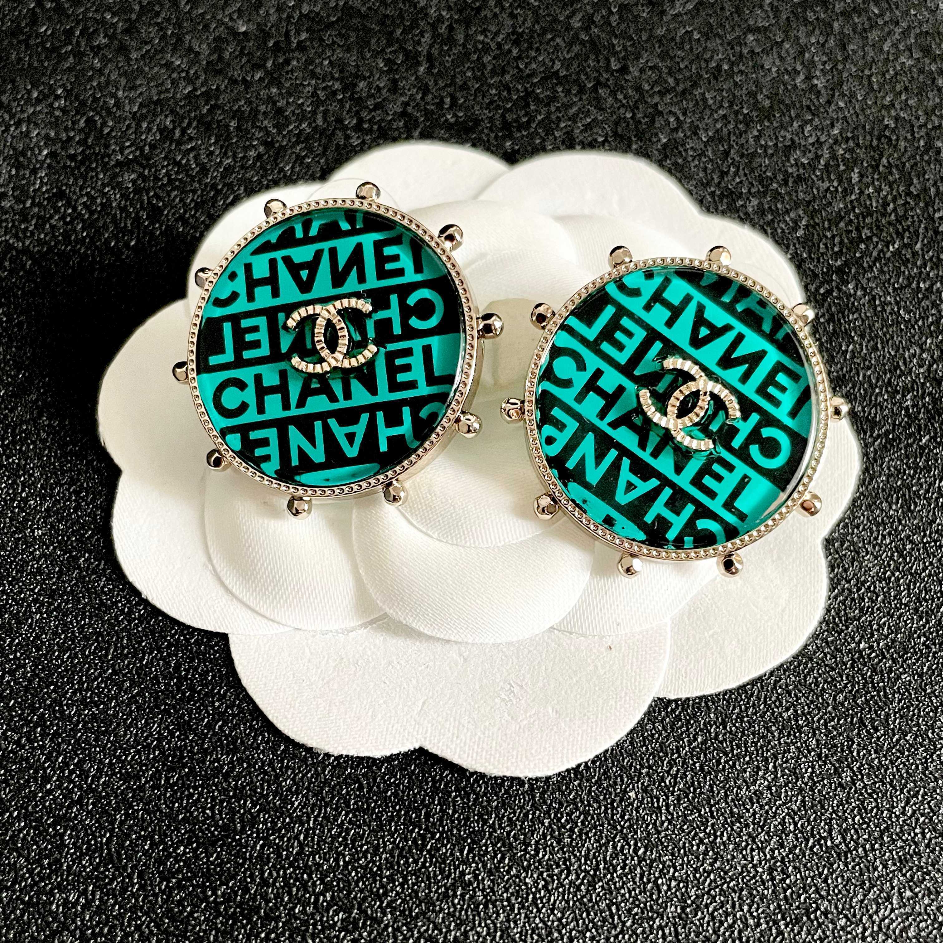 Chanel CC Logo Round Stud Earrings earrings Light gold-tone metal with turquoise and black enamel crystal-embellished interlocking CC logo 2 5cm diameter