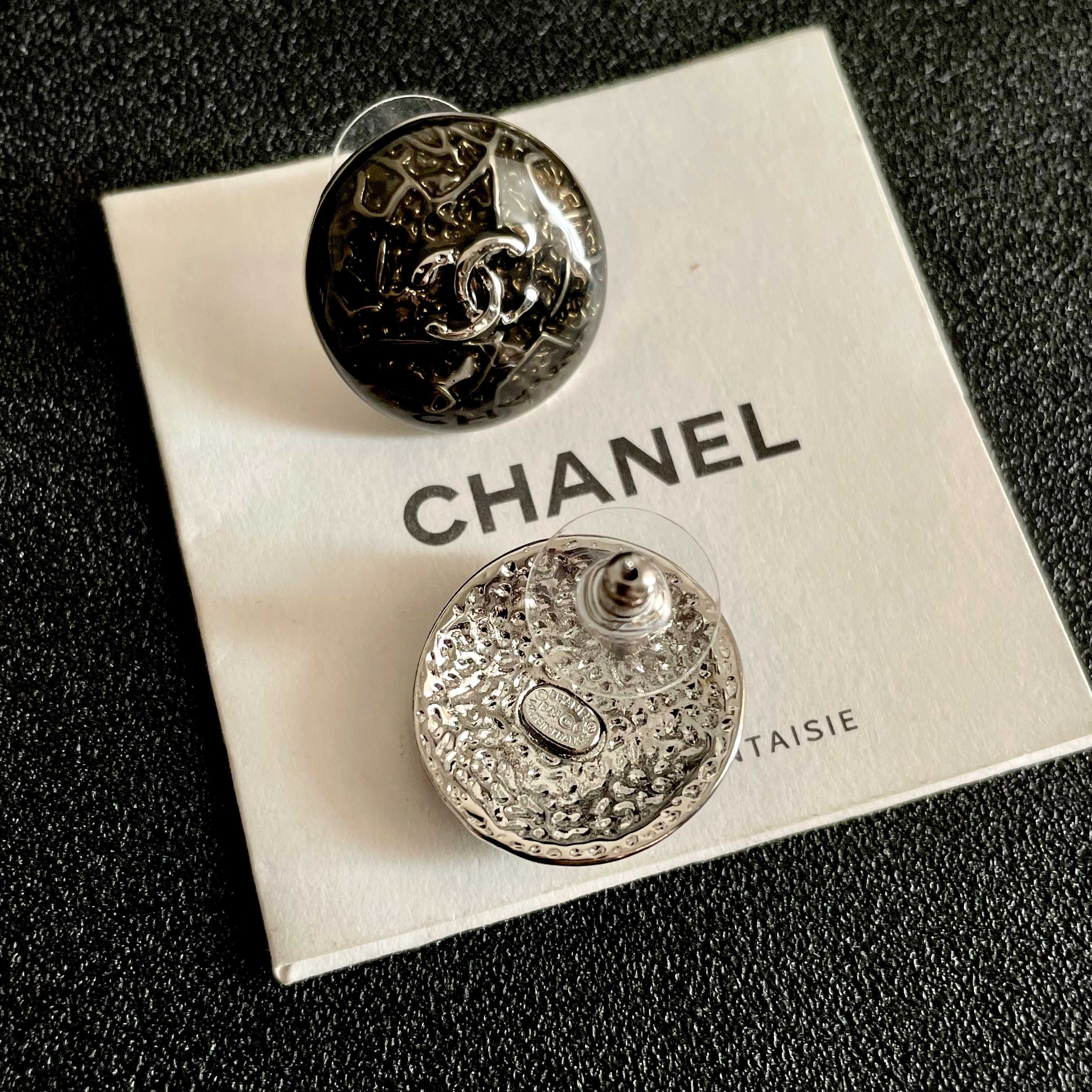 Chanel CC Logo Round Button Stud Earrings earrings ruthenium dark gunmetal with silver-tone interlocking CC logo dark translucent resin base with silver filigree detailing 1 5cm diameter