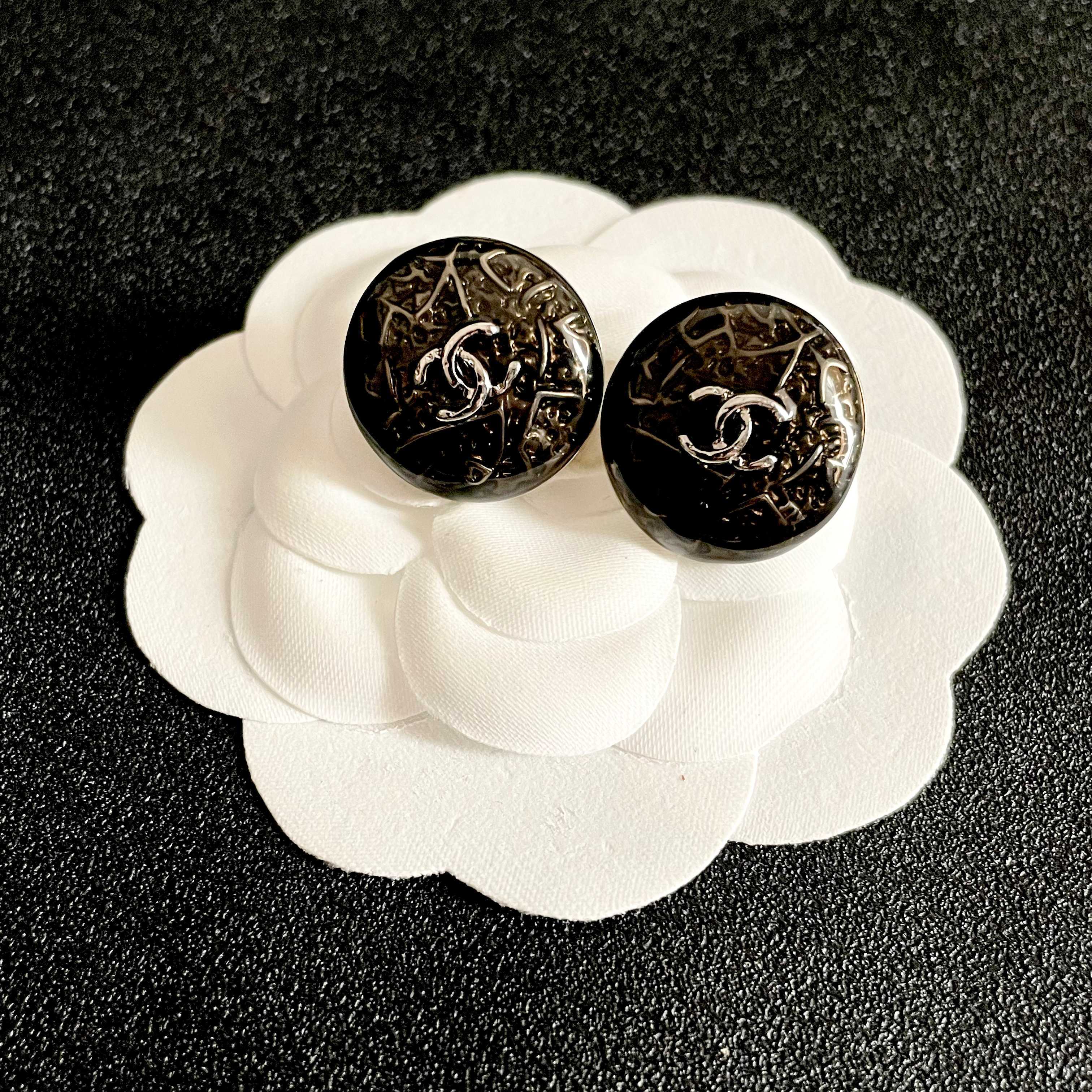 Chanel CC Logo Round Button Stud Earrings earrings ruthenium dark gunmetal with silver-tone interlocking CC logo dark translucent resin base with silver filigree detailing 1 5cm diameter