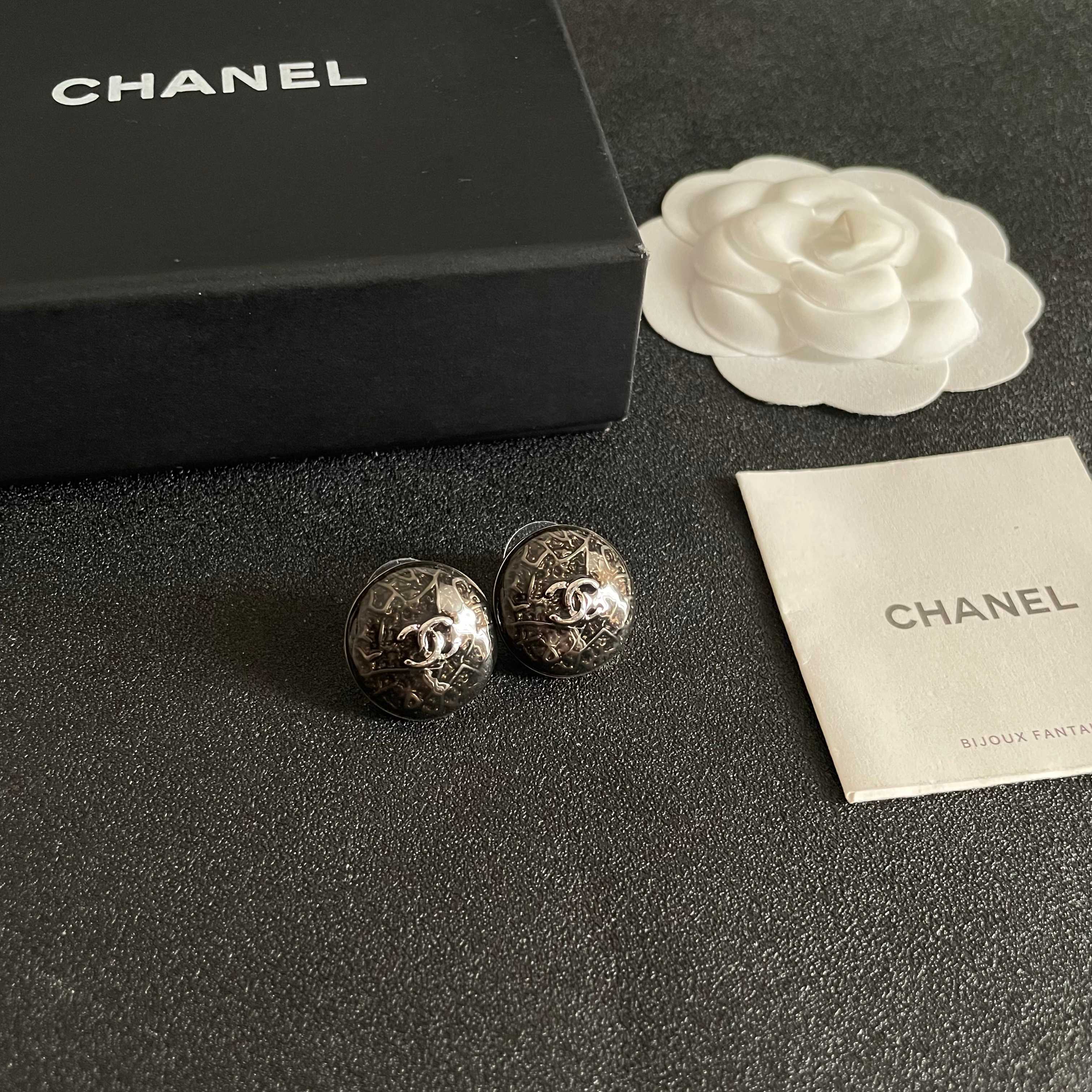 Chanel CC Logo Round Button Stud Earrings earrings ruthenium dark gunmetal with silver-tone interlocking CC logo dark translucent resin base with silver filigree detailing 1 5cm diameter