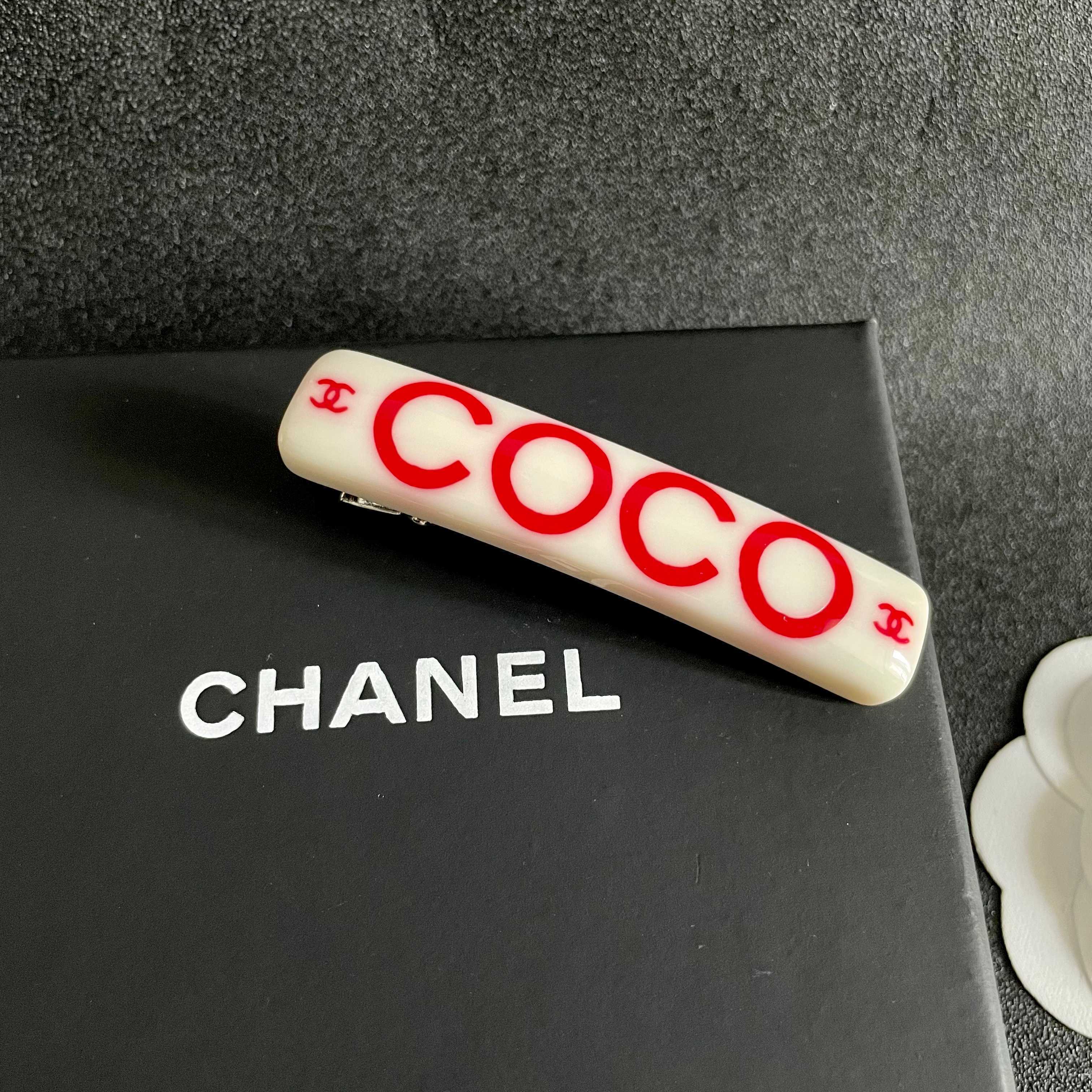 Chanel COCO brooch white base with red printed logos and text 6cm