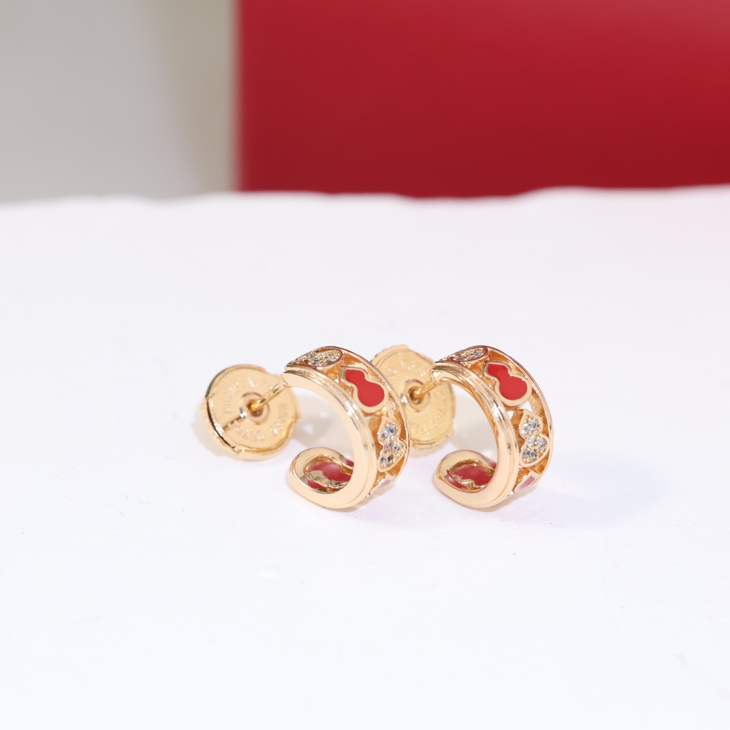 Qeelin Wulu earrings gold-tone metal red enamel clear diamond simulants 10mm hoop diameter