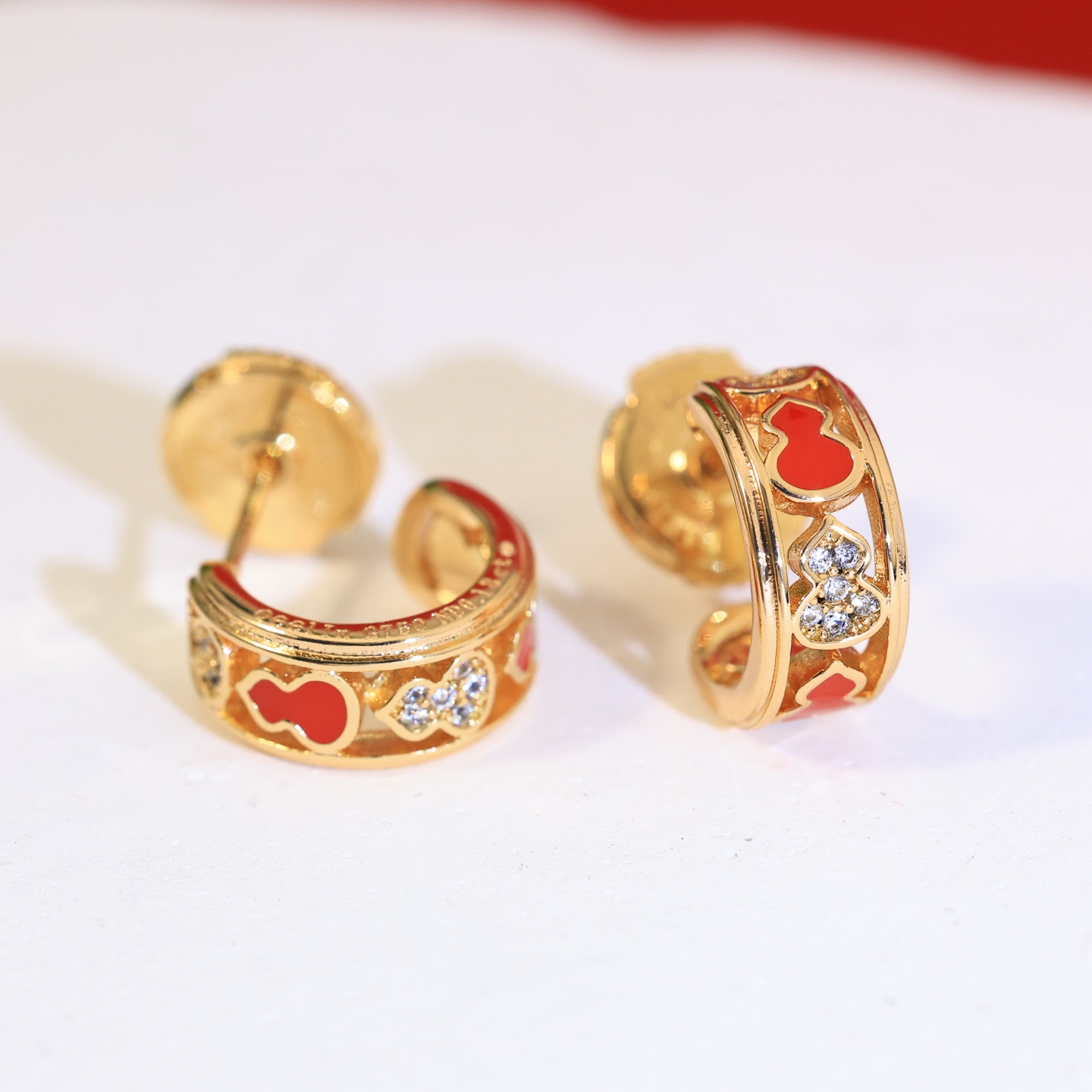 Qeelin Wulu earrings gold-tone metal red enamel clear diamond simulants 10mm hoop diameter