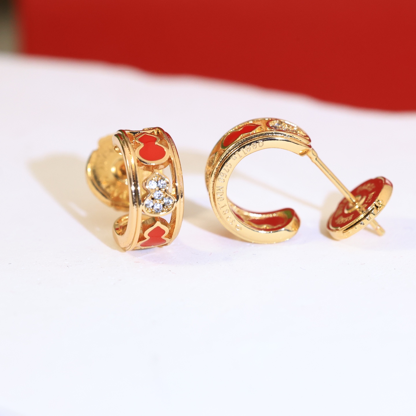 Qeelin Wulu earrings gold-tone metal red enamel clear diamond simulants 10mm hoop diameter