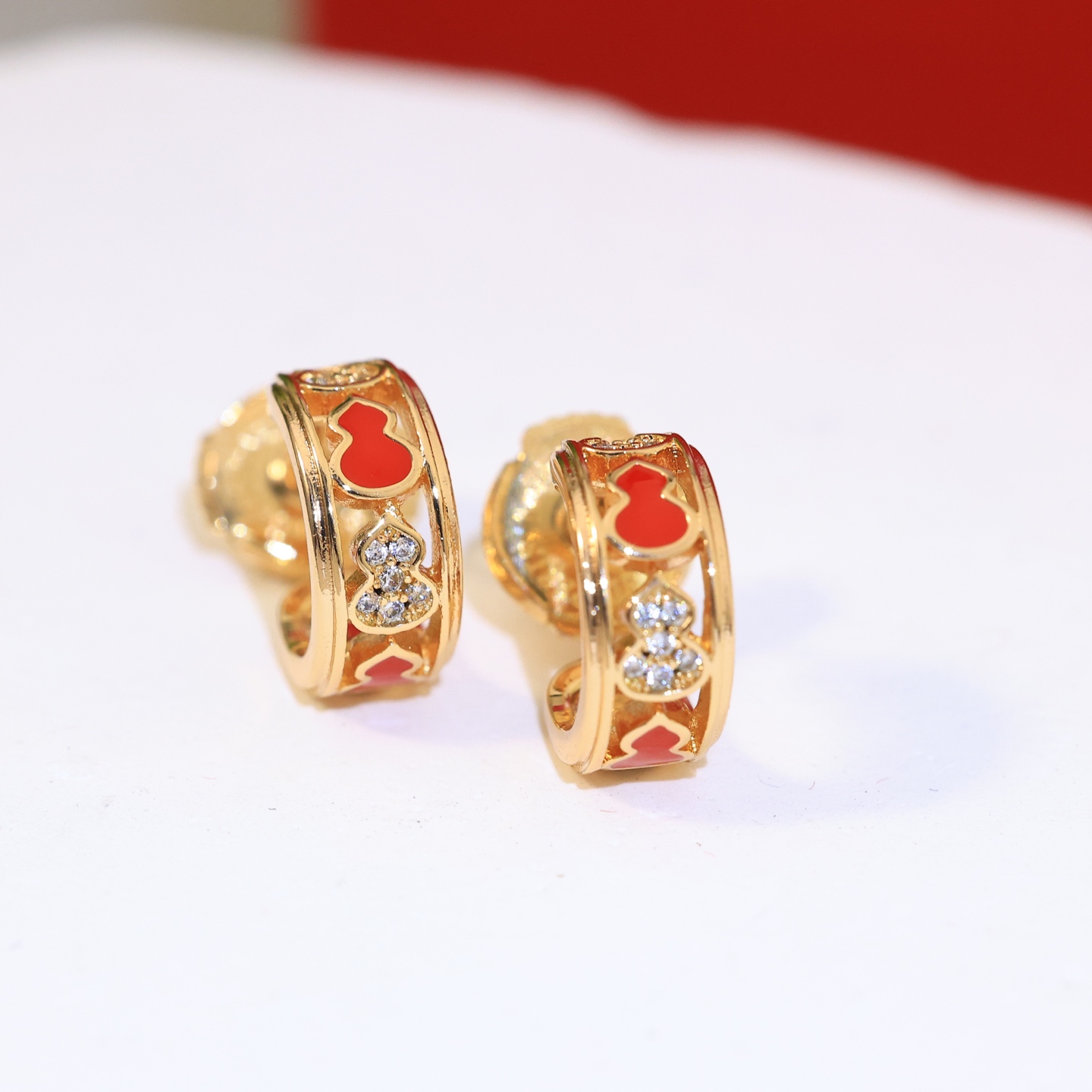 Qeelin Wulu earrings gold-tone metal red enamel clear diamond simulants 10mm hoop diameter