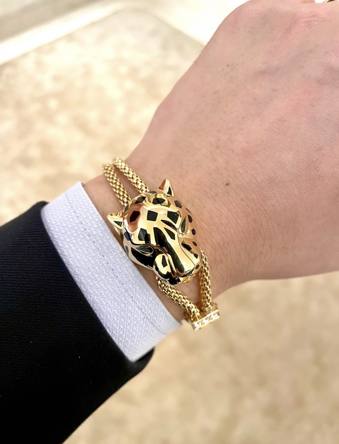 Cartier Panthere de Cartier bracelet 18k yellow gold black lacquer spots emerald green eyes diamond accent on slider adjustable sliding chain fits 15-19cm wrist