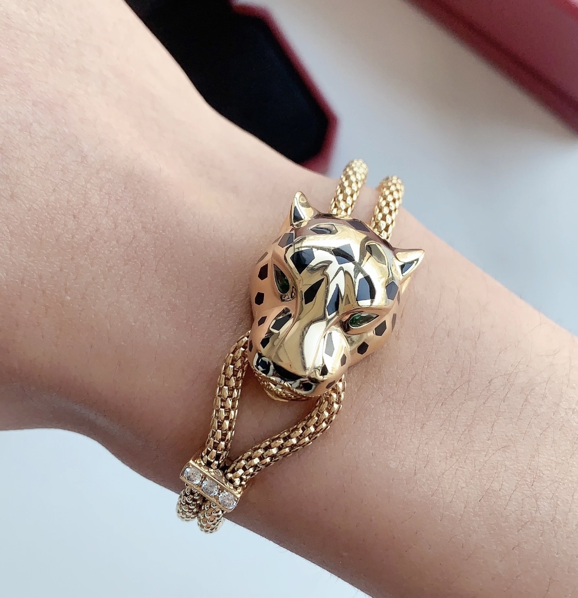 Cartier Panthere de Cartier bracelet 18k yellow gold black lacquer spots emerald green eyes diamond accent on slider adjustable sliding chain fits 15-19cm wrist