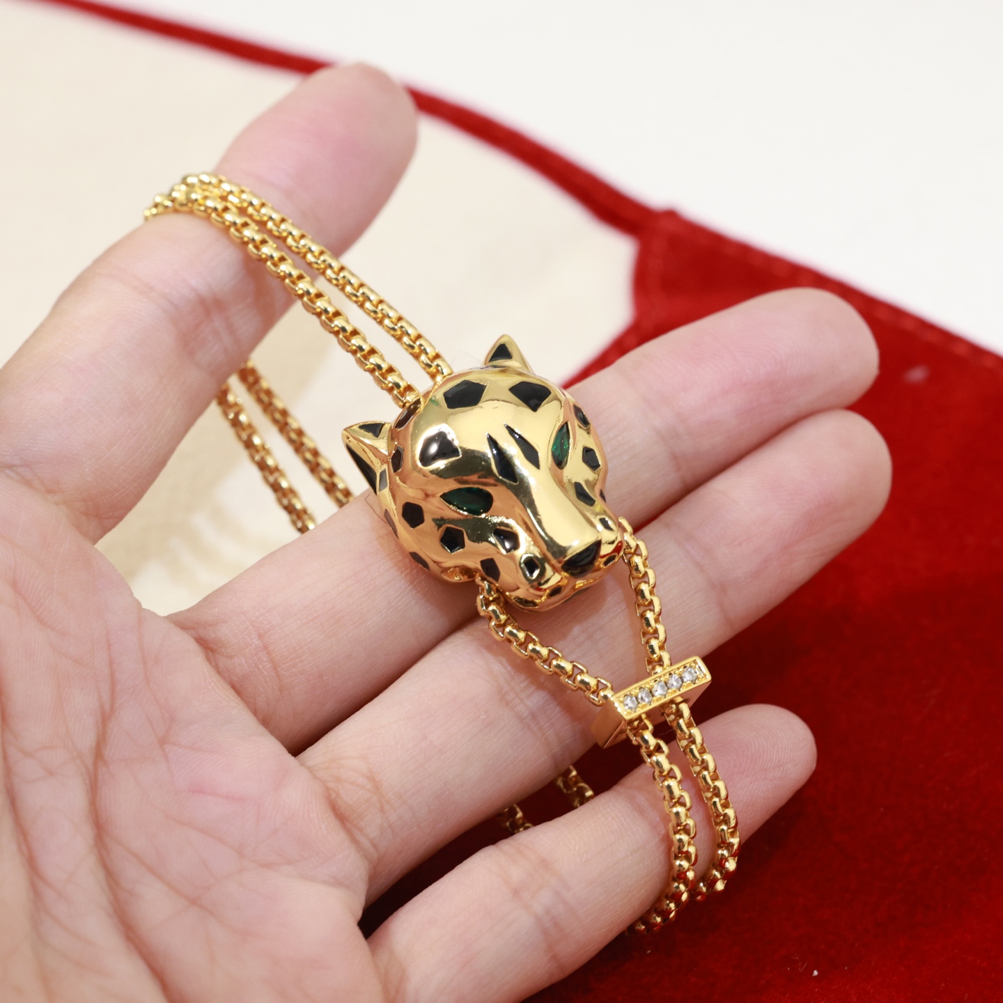 Cartier Panthere de Cartier bracelet 18k yellow gold black lacquer spots emerald green eyes diamond accent on slider adjustable sliding chain fits 15-19cm wrist