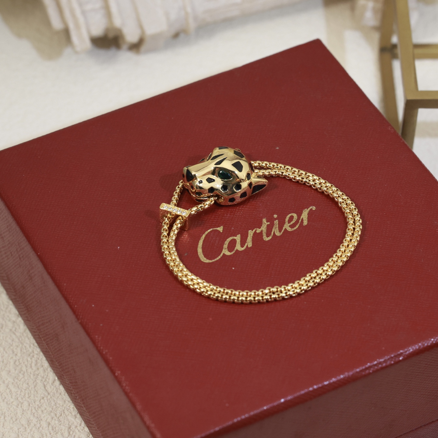 Cartier Panthere de Cartier bracelet 18k yellow gold black lacquer spots emerald green eyes diamond accent on slider adjustable sliding chain fits 15-19cm wrist