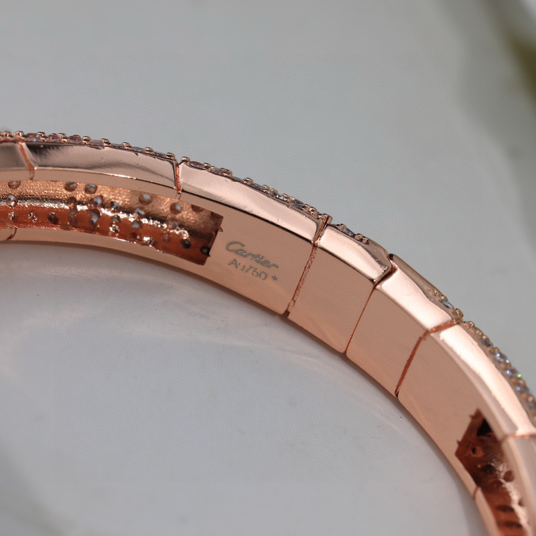 Cartier Panthere de Cartier bracelet Available in 18K white gold 18K rose gold 18K yellow gold fully paved with clear diamonds black onyx spots emerald green panther eyes 17