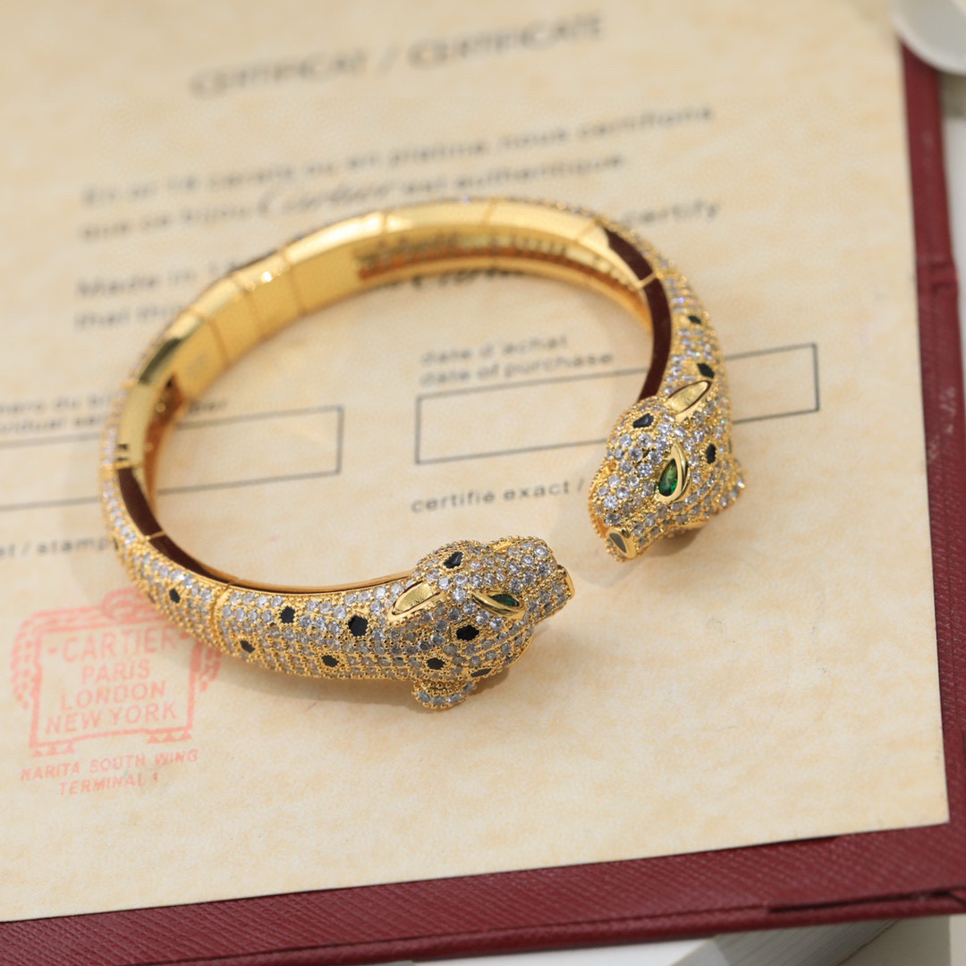 Cartier Panthere de Cartier bracelet Available in 18K white gold 18K rose gold 18K yellow gold fully paved with clear diamonds black onyx spots emerald green panther eyes 17