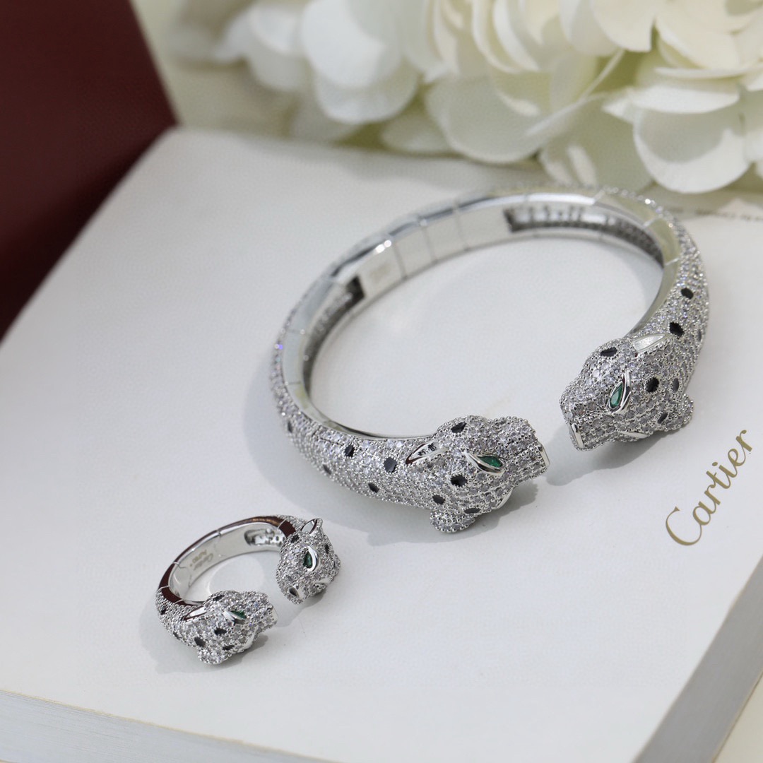 Cartier Panthere de Cartier bracelet Available in 18K white gold 18K rose gold 18K yellow gold fully paved with colorless diamonds black onyx spots green tsavorite garnet eyes 17cm