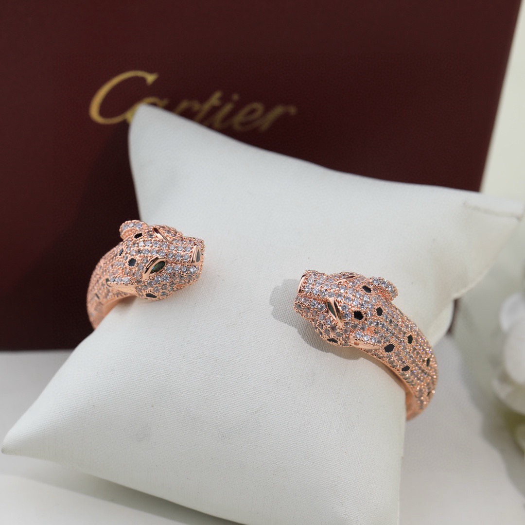 Cartier Panthere de Cartier bracelet Available in 18K white gold 18K rose gold 18K yellow gold fully paved with colorless diamonds black onyx spots green tsavorite garnet eyes 17cm